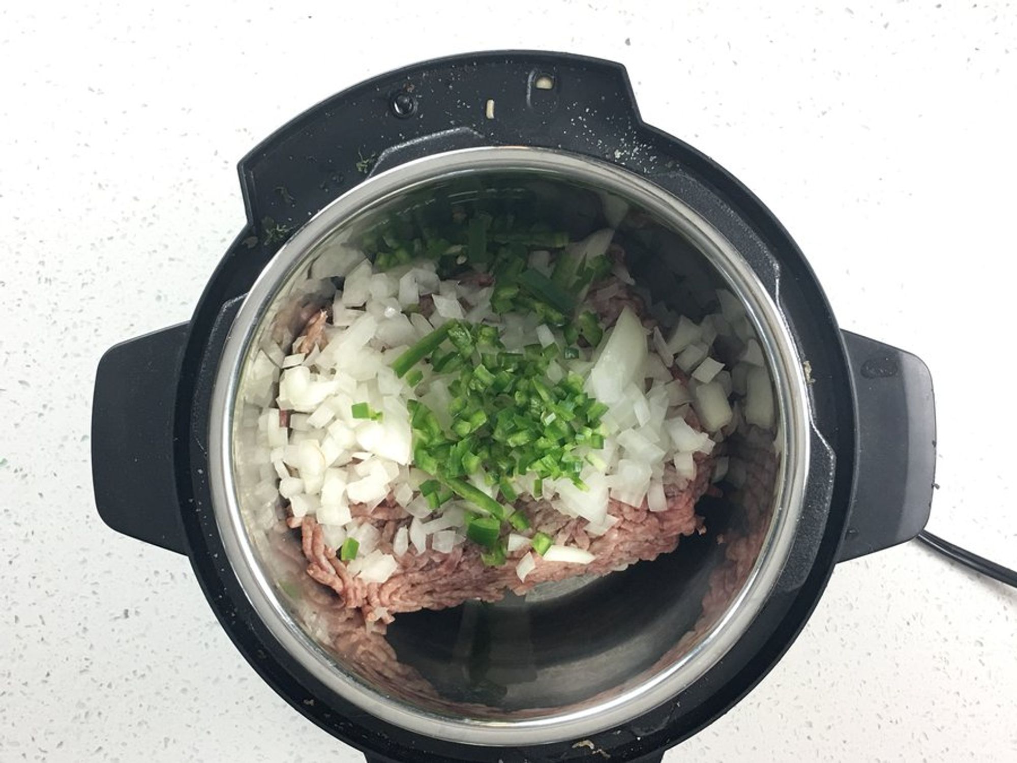 ground beef, onions,  jalapeños, garlic and spices in an instant pot