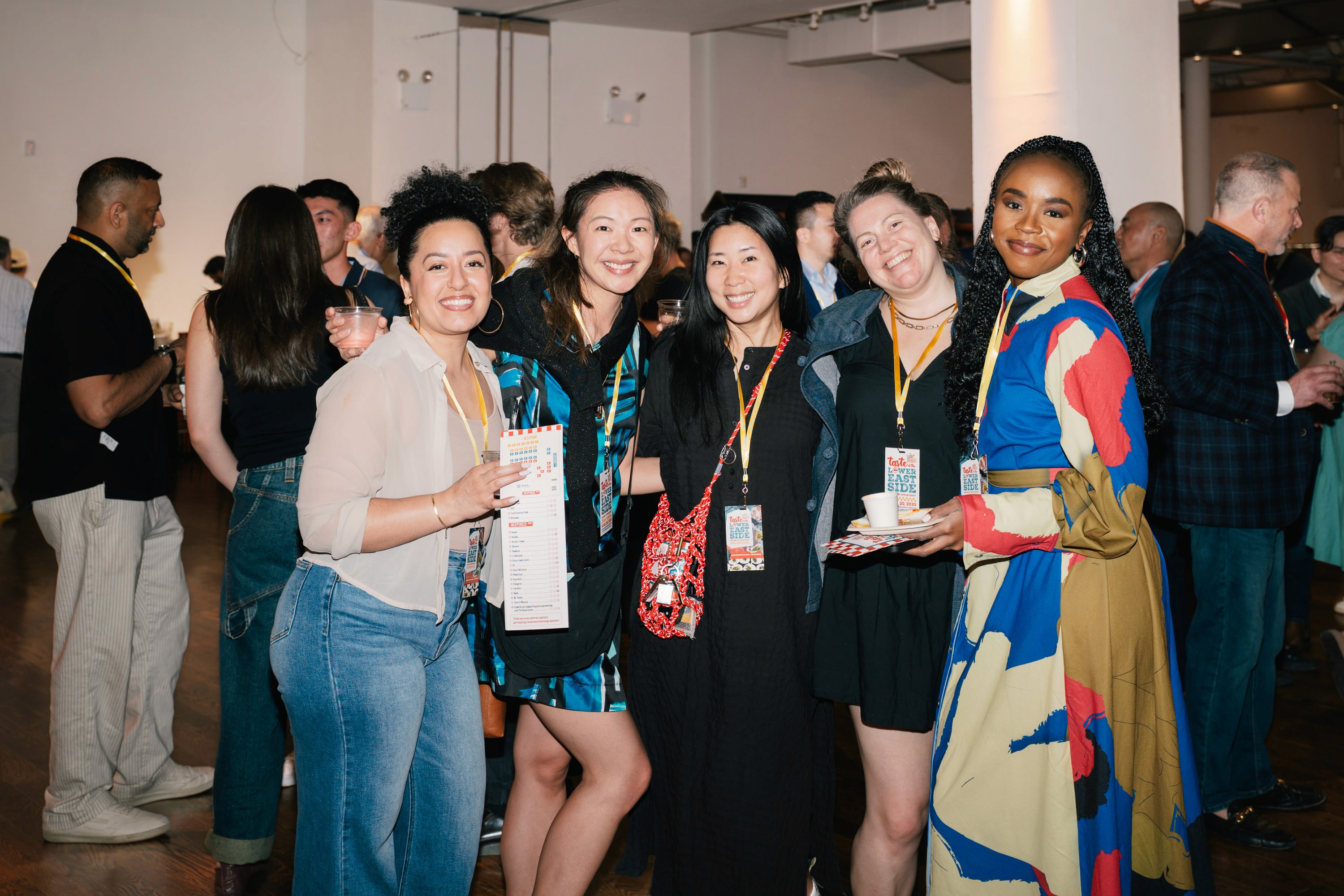 Five women attending an event pose for a friendly photo