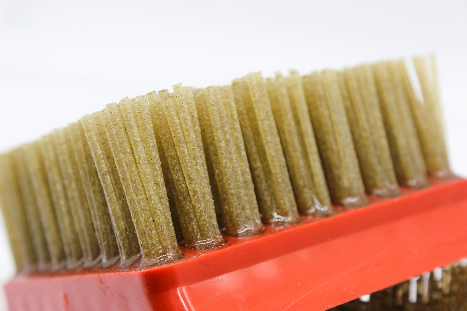 Close-up side view of the diamond abrasive brush, emphasizing the length and density of the bristles.