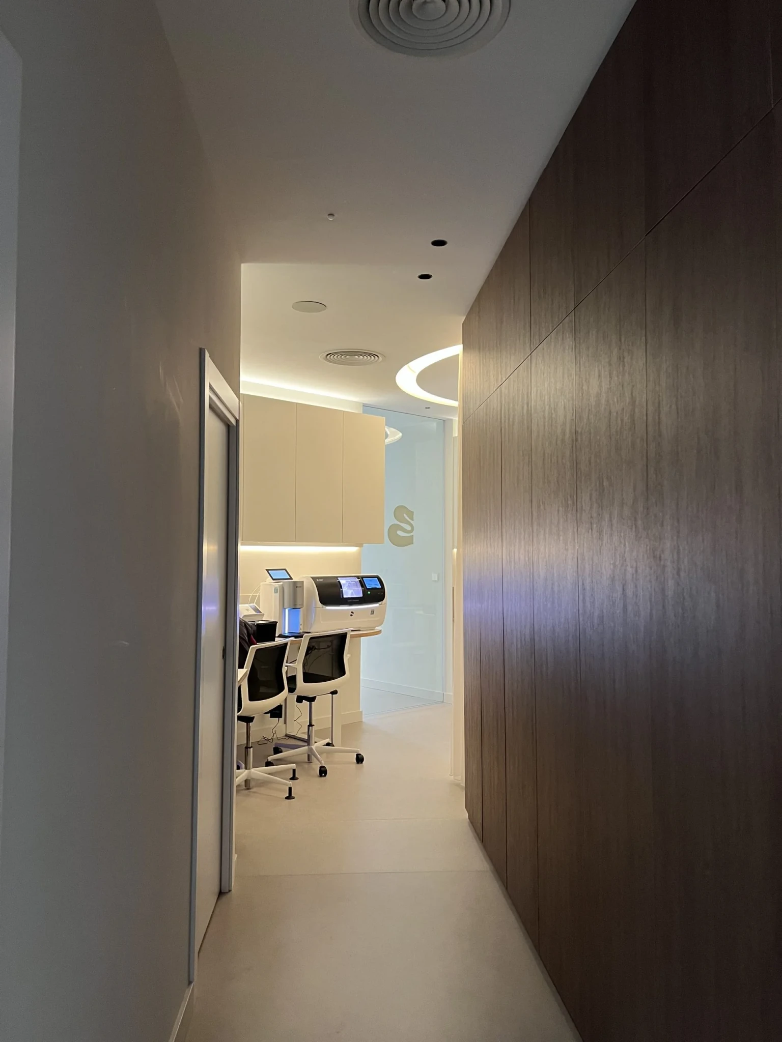 Golden cross atop a domed building with blue sky.