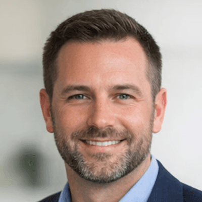 a man in a blue suit posing for a picture