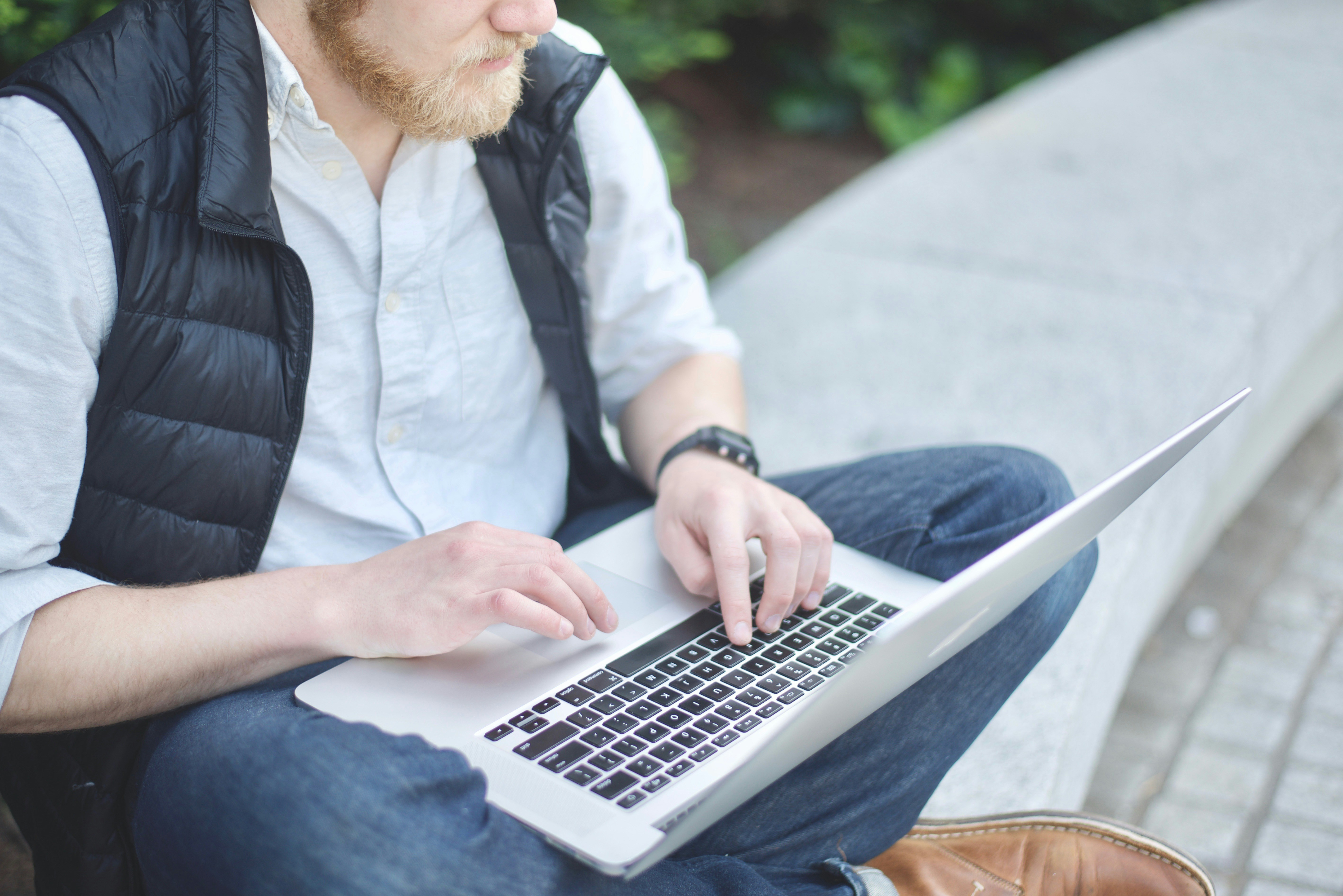 person trying to work on laptop - How To Trade Cryptocurrency