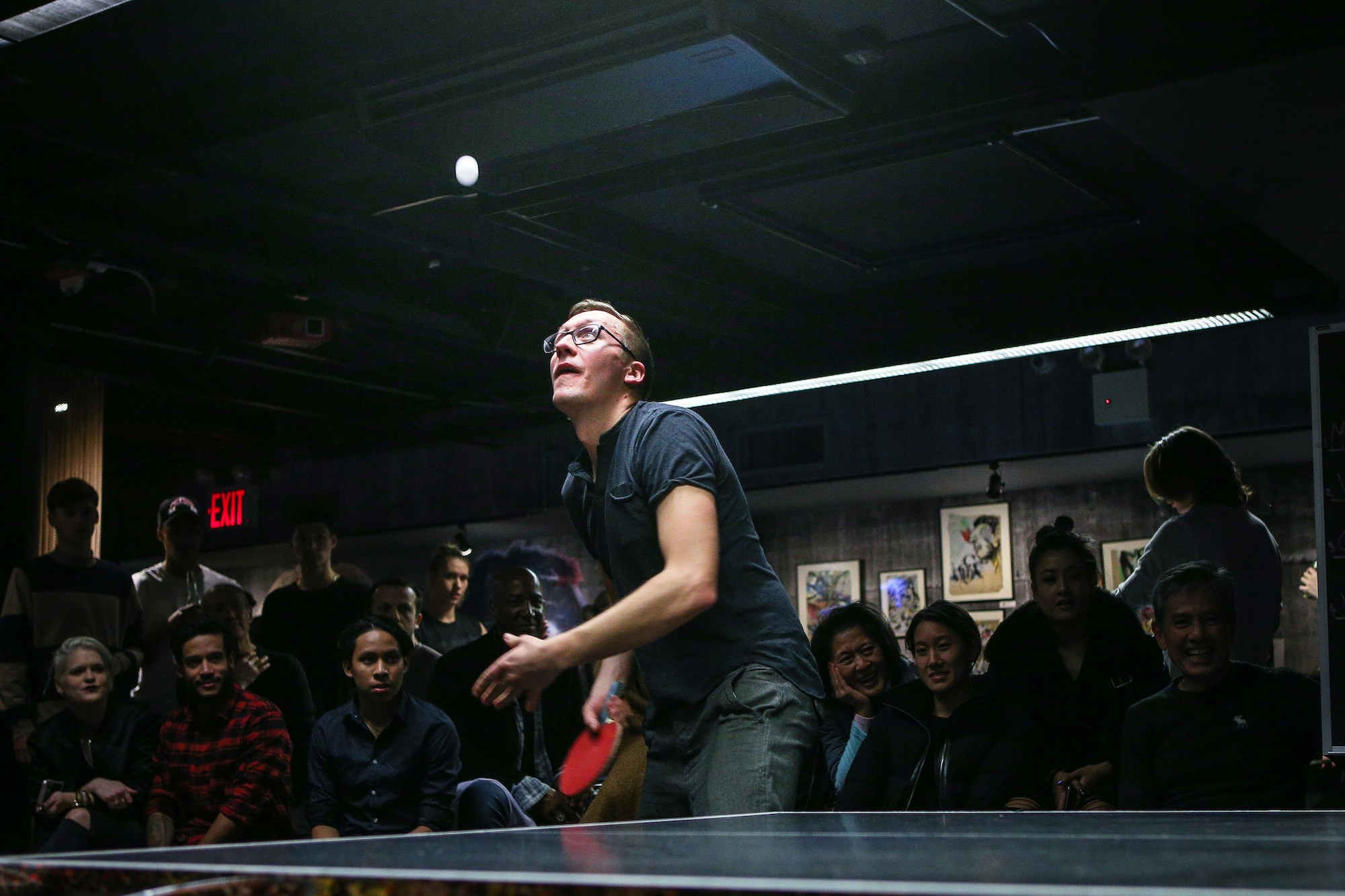 two ping pong paddles and a ping pong ball on a blue table