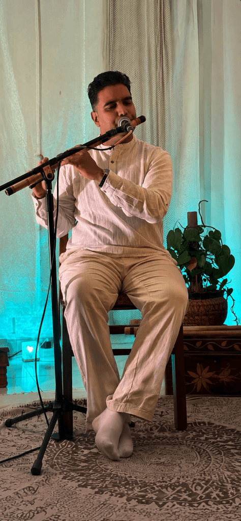 Indian bamboo flute artist performing live at an intimate acoustic event