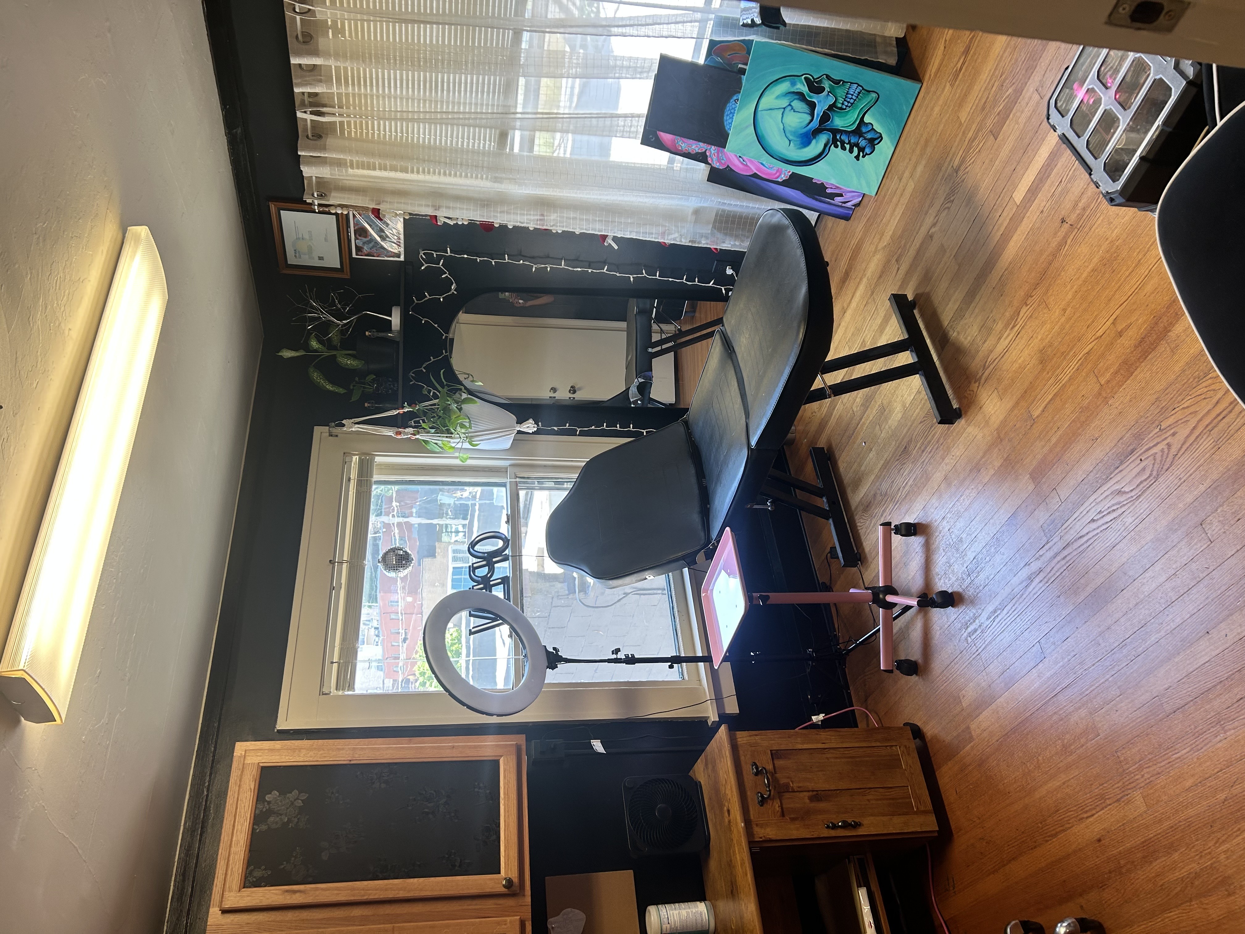 Private tattoo room setup with chair and supplies