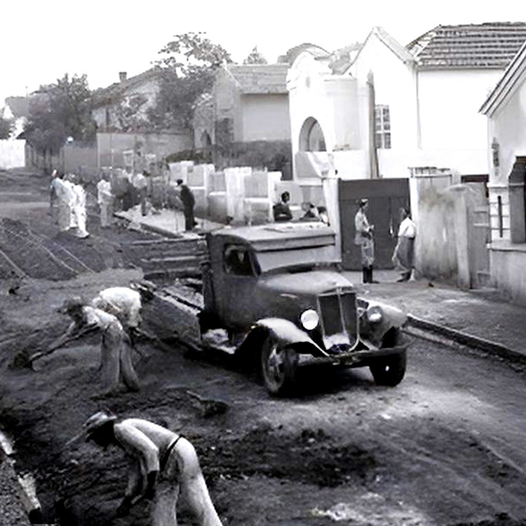 Three children walk along a dirt path.