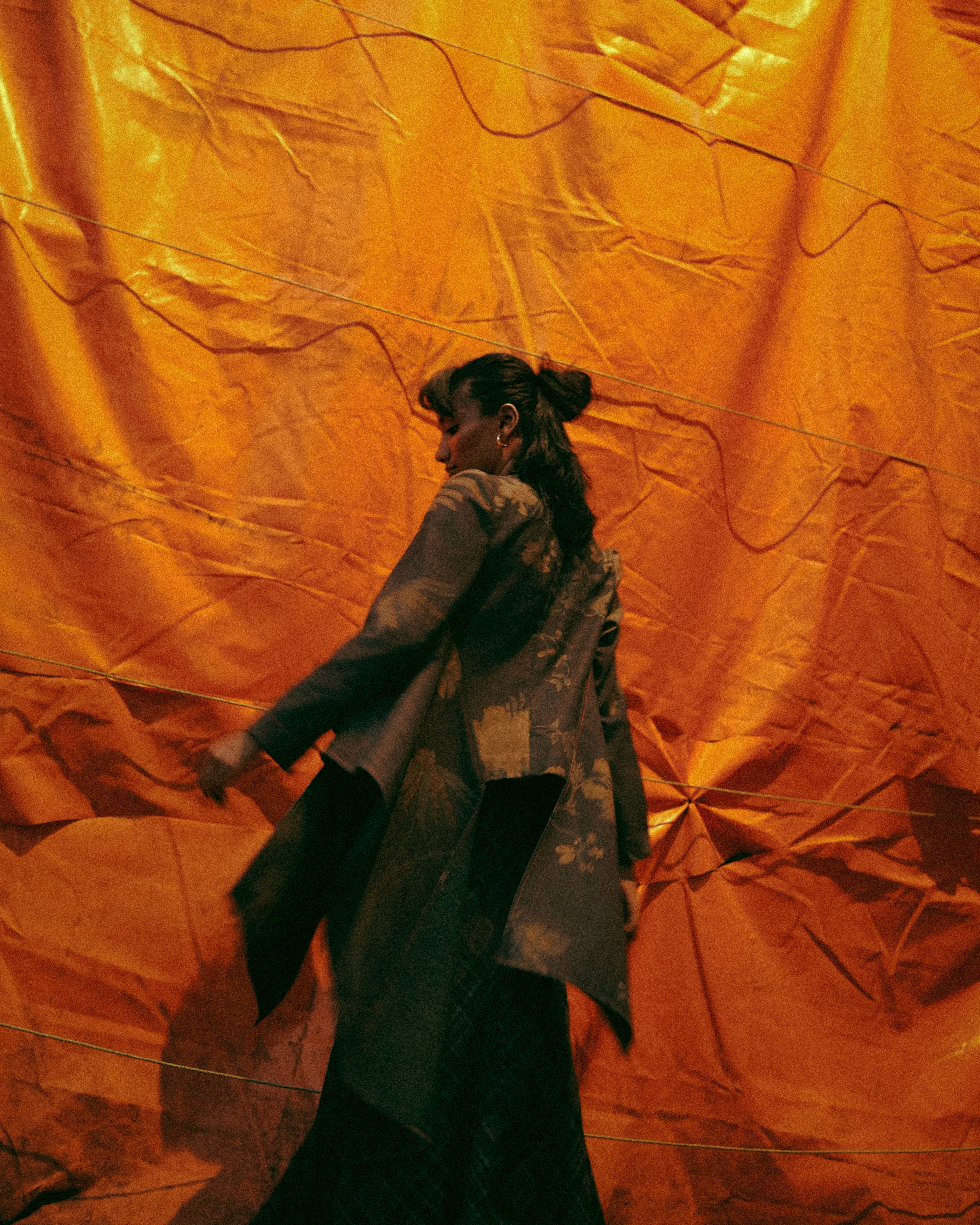 Astronaut standing on lunar surface under dim light