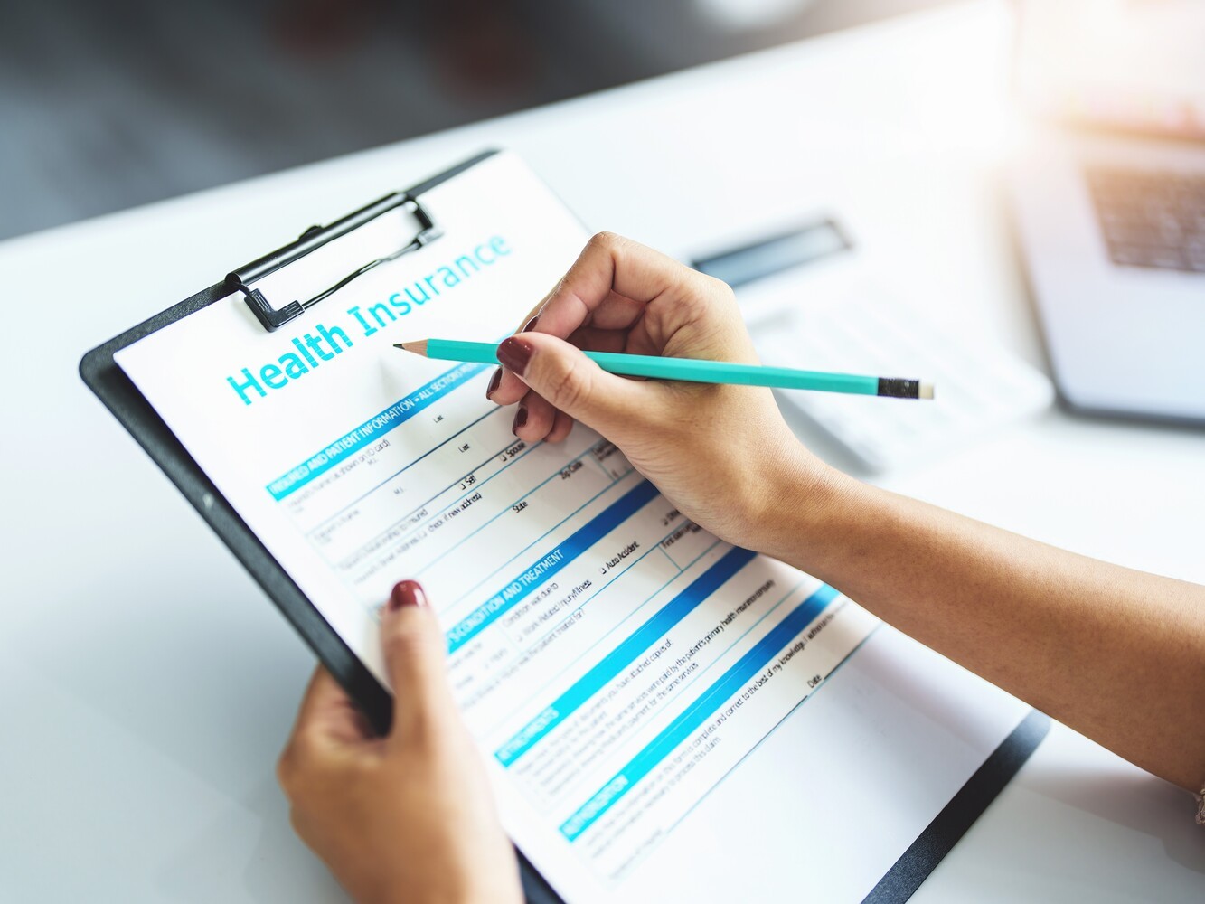 woman filling out a health insurance form so that she can be covered for her plan for how to lose weight with diabetes