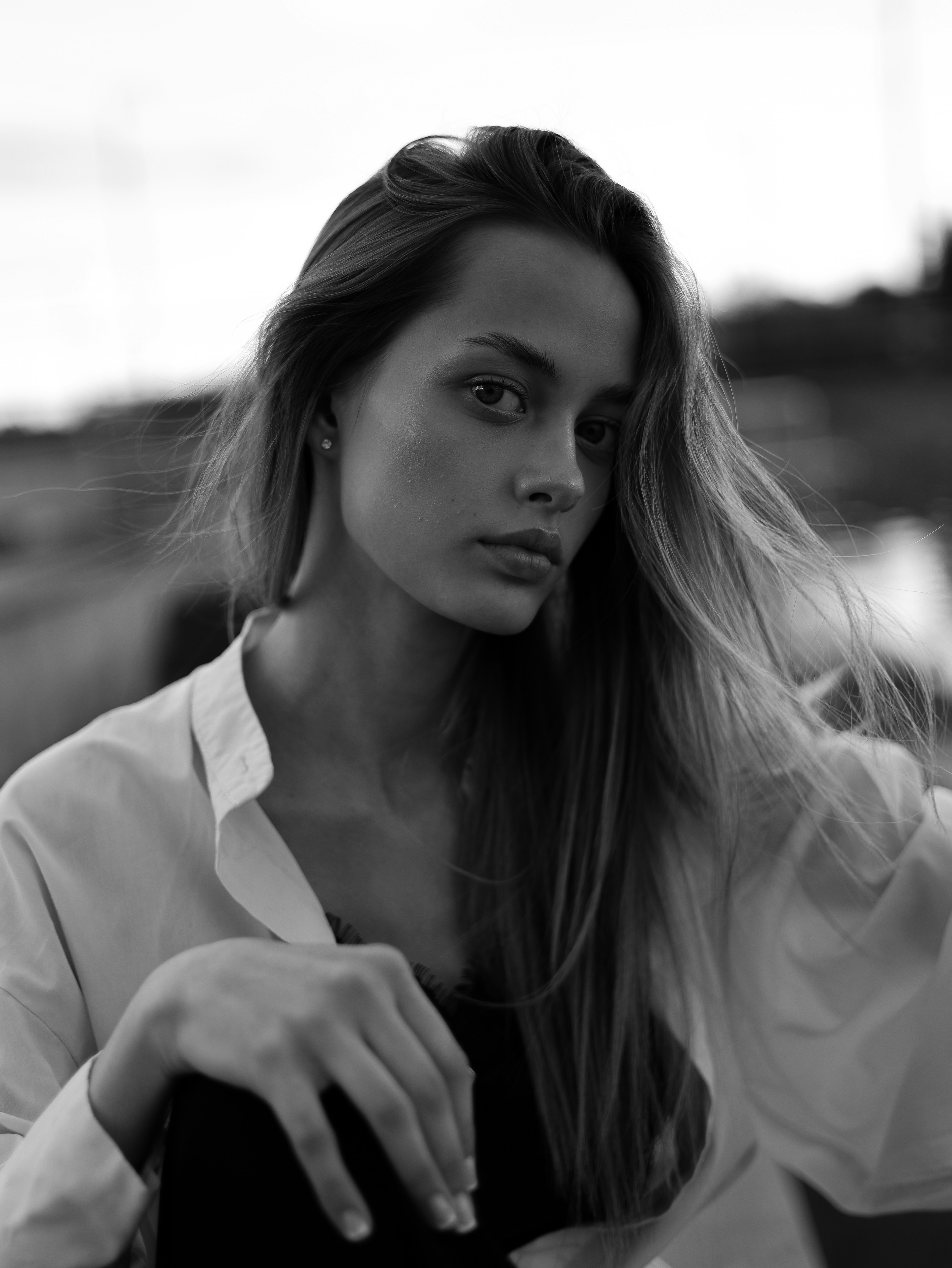 A young woman with long hair looking at the camera