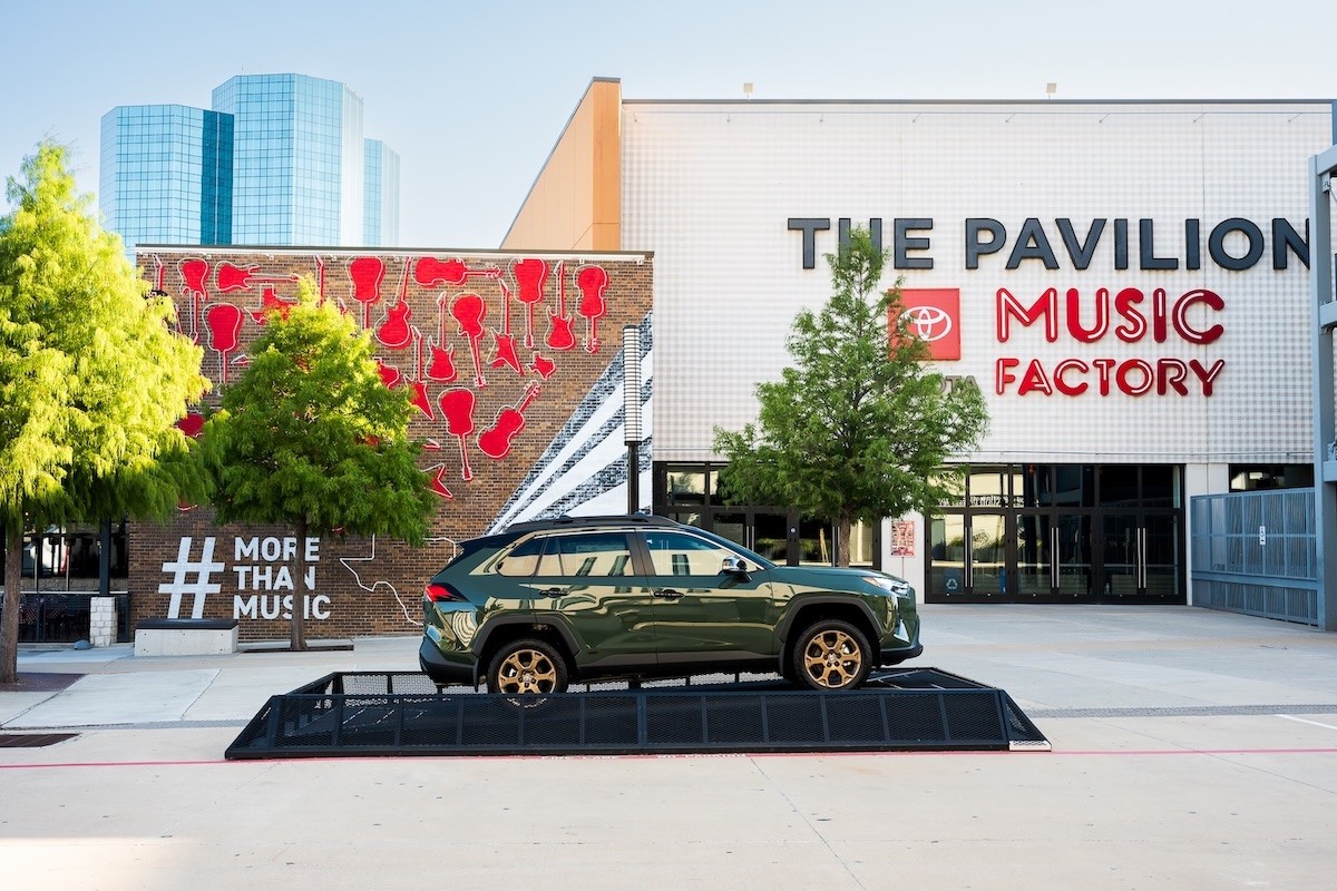 Green Toyota RAV4 vehicle parked in front of the #MoreThanMusic mural in front of The Pavilion at Toyota Music Factory in Irving, Texas.