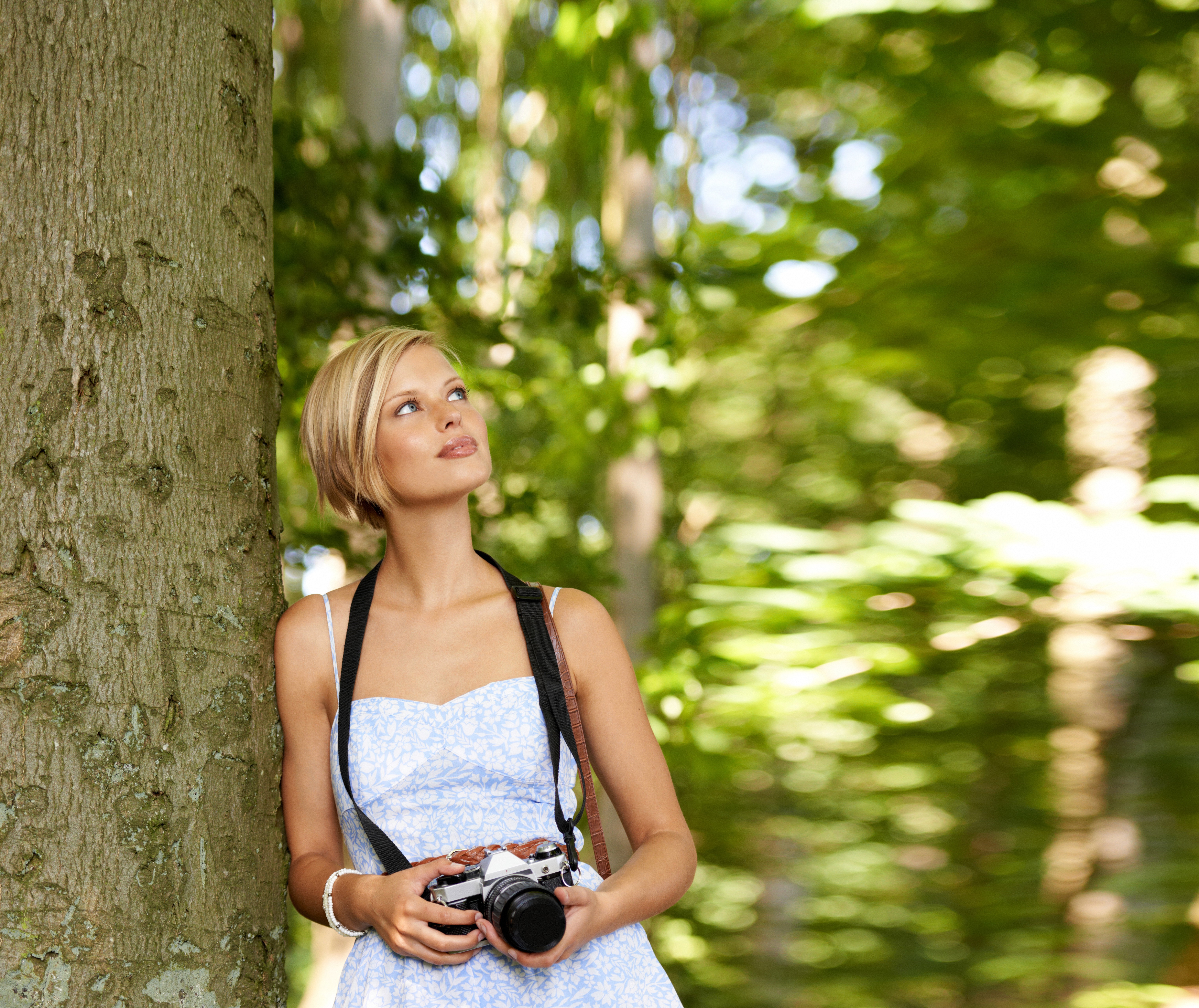 Elara Rose in the woods with a camera