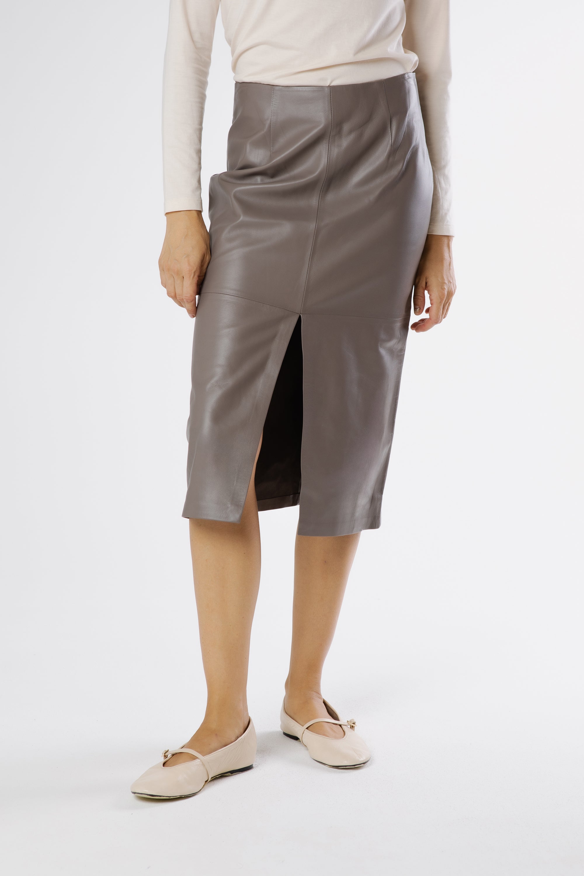 Side view of Selina leather midi skirt in stone taupe highlighting sleek fit and modern midi length.