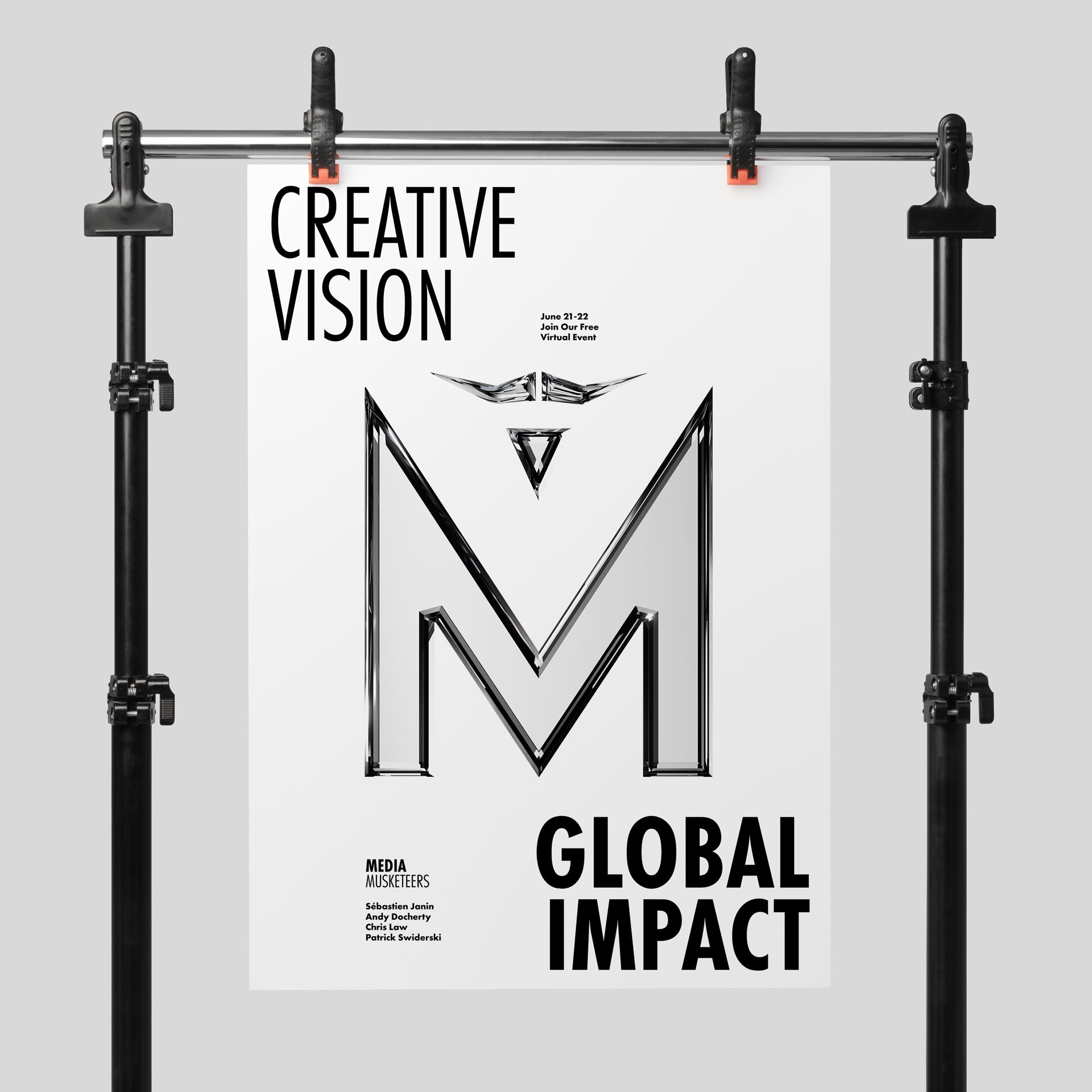 Black and white poster suspended from a metal frame, displaying 'CREATIVE VISION' at the top and 'GLOBAL IMPACT' at the bottom, with the shiny Media Musketeers logo centered between the text