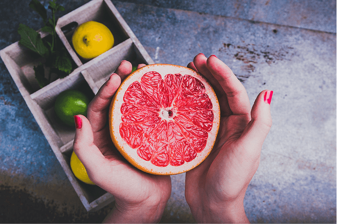 Woman holding grapefruit