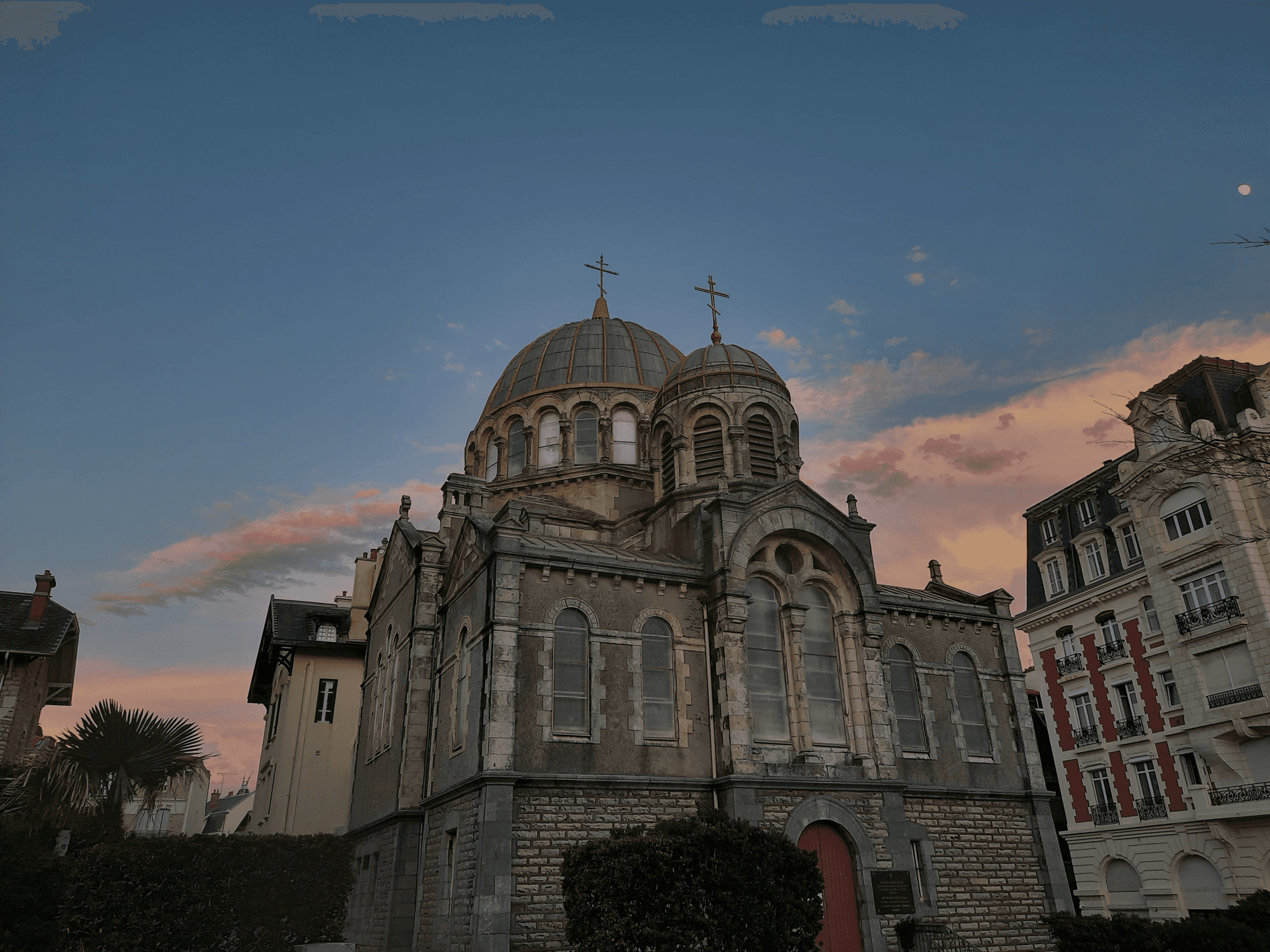Panoramic view of San Sebastian, Spain. The city is nestled between two hills and a beautiful bay filled with boats.