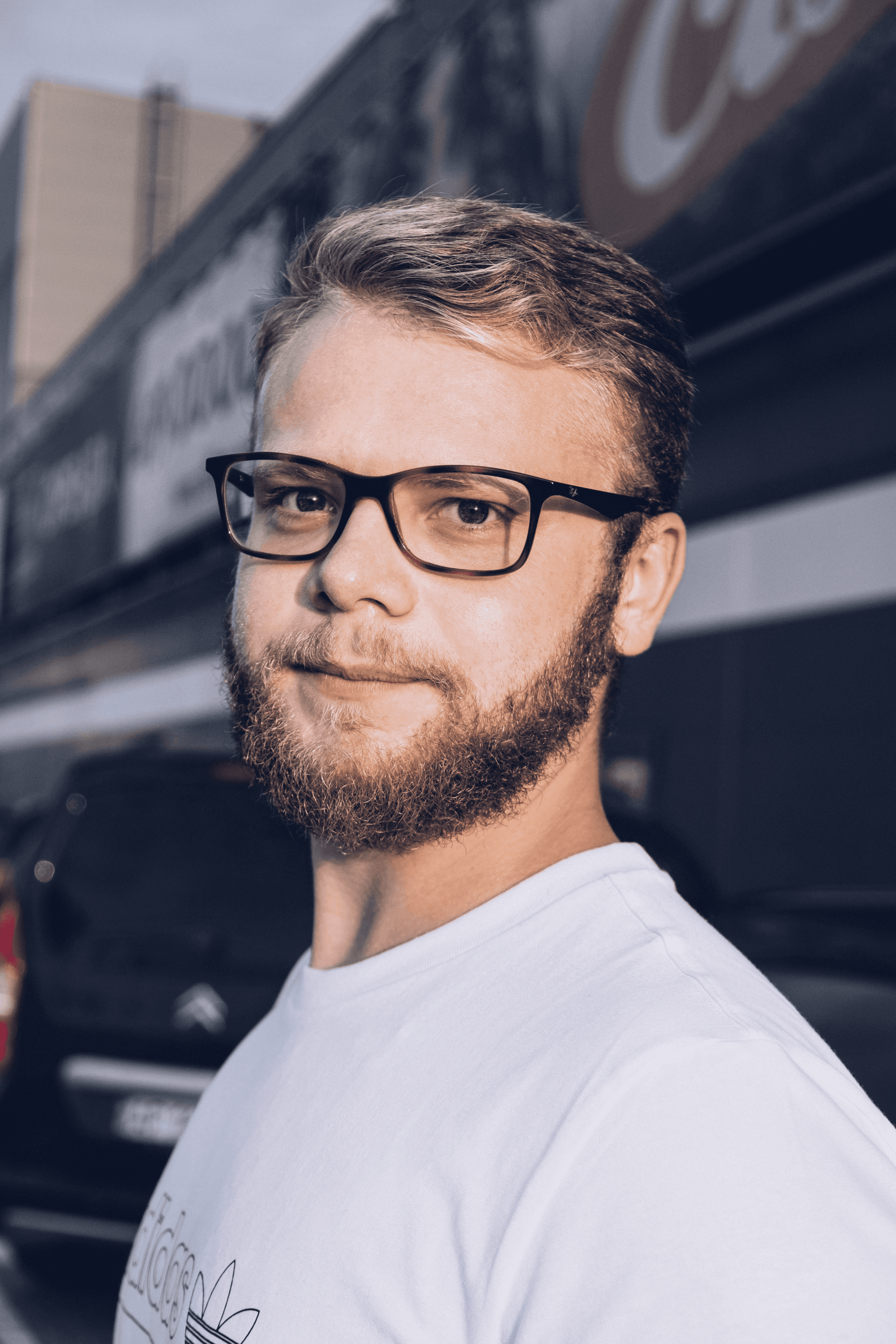 man in white crew neck shirt wearing black framed eyeglasses