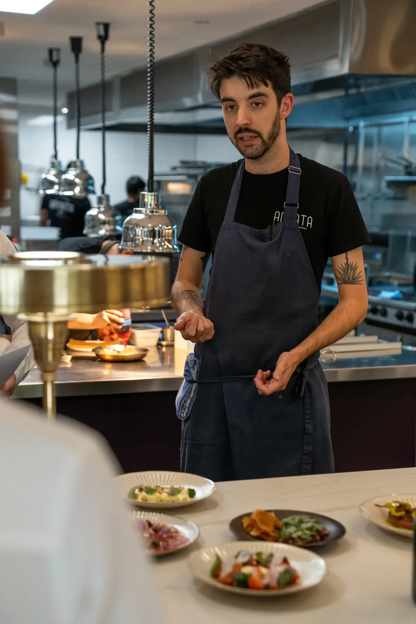 Jordon Garcia, Executive Chef, presenting dishes at the ANNATA kitchen pass