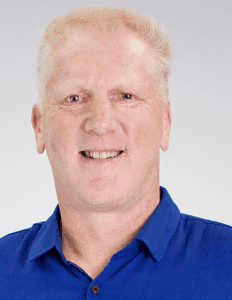 Black and white portrait of a smiling person with curly hair