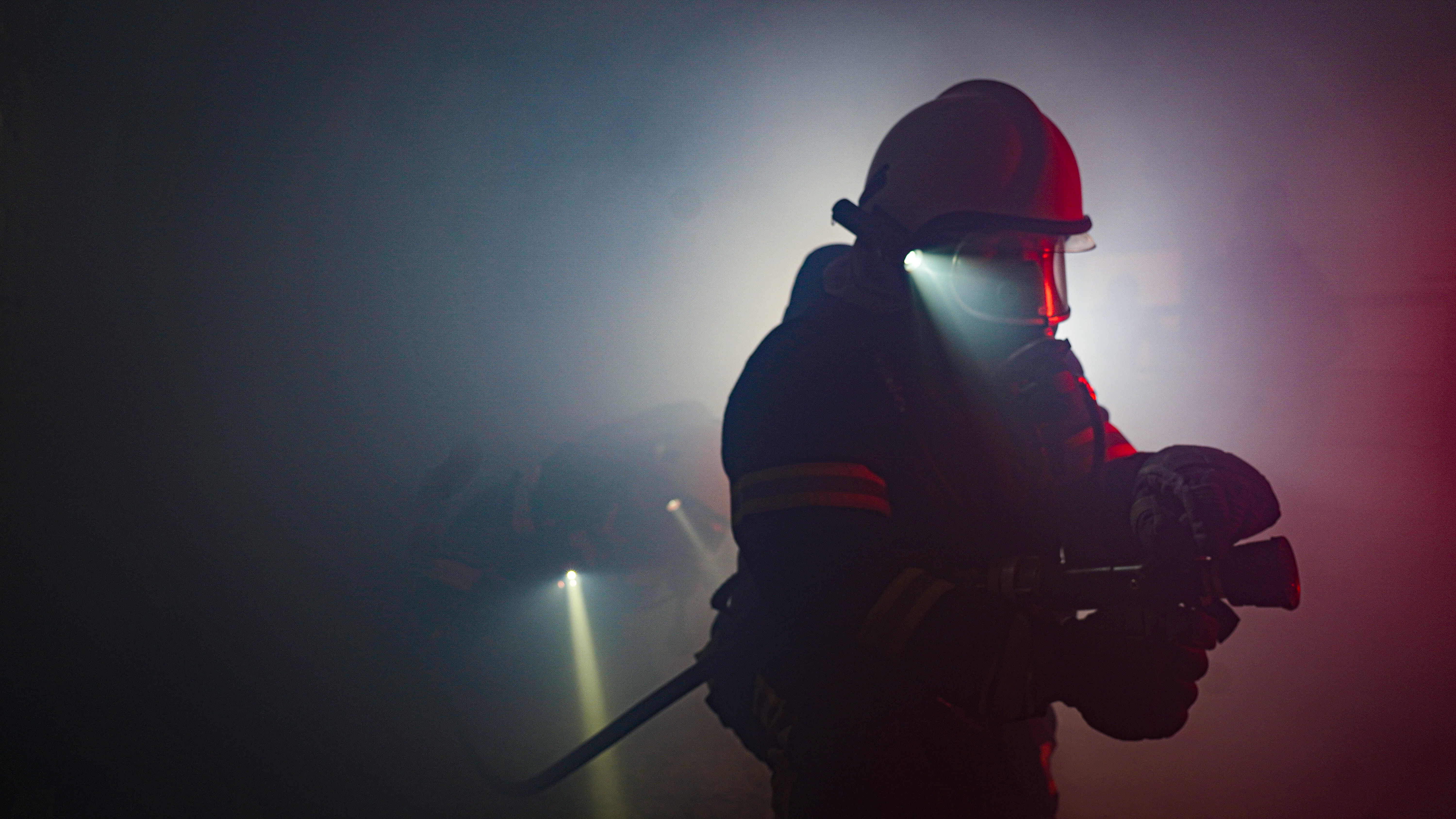 firefighter searching & rescuing fire zone