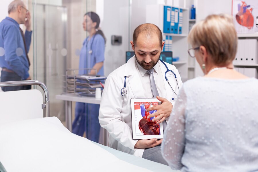 A doctor showing and discussing his patients reports.