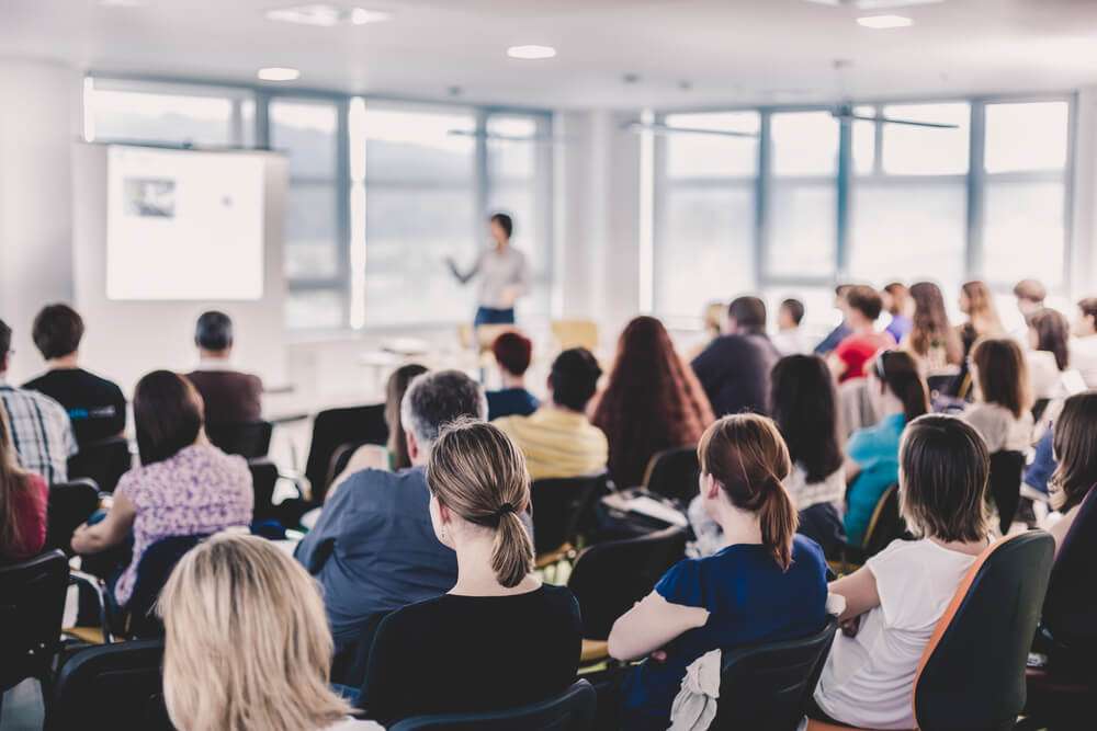 Group of people watching a lecture