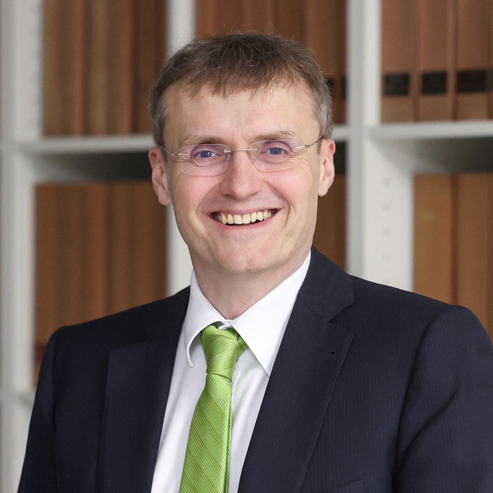 a man in a blue suit posing for a picture