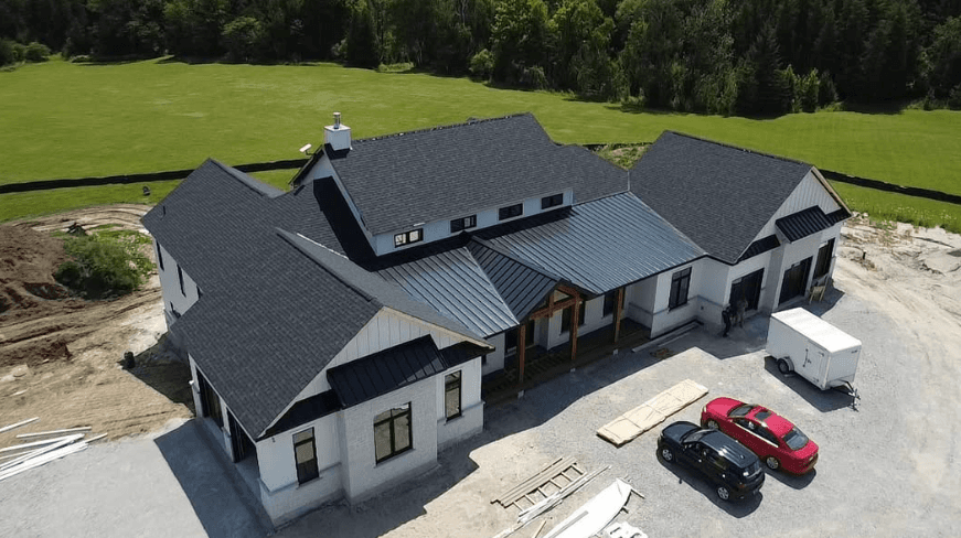 a man in a yellow shirt is working on a roof