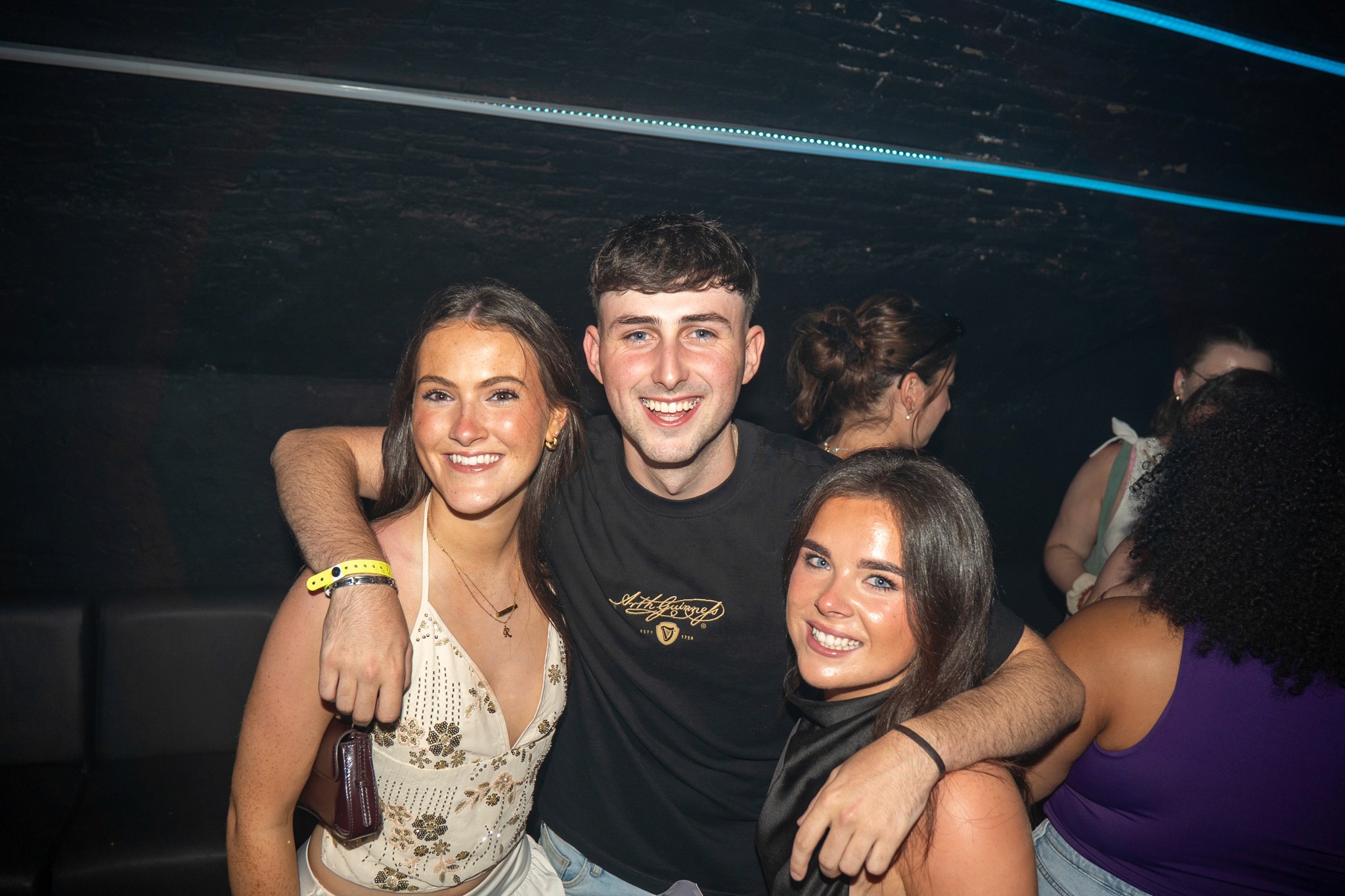 Group of young travelers smiling together during a guided pub crawl in Nice showing a safe and friendly nightlife atmosphere in the French Riviera
