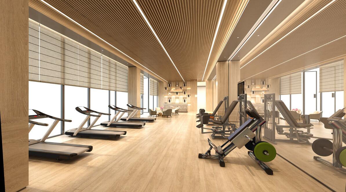 A gym room featuring several treadmills and large mirrors reflecting the workout space.