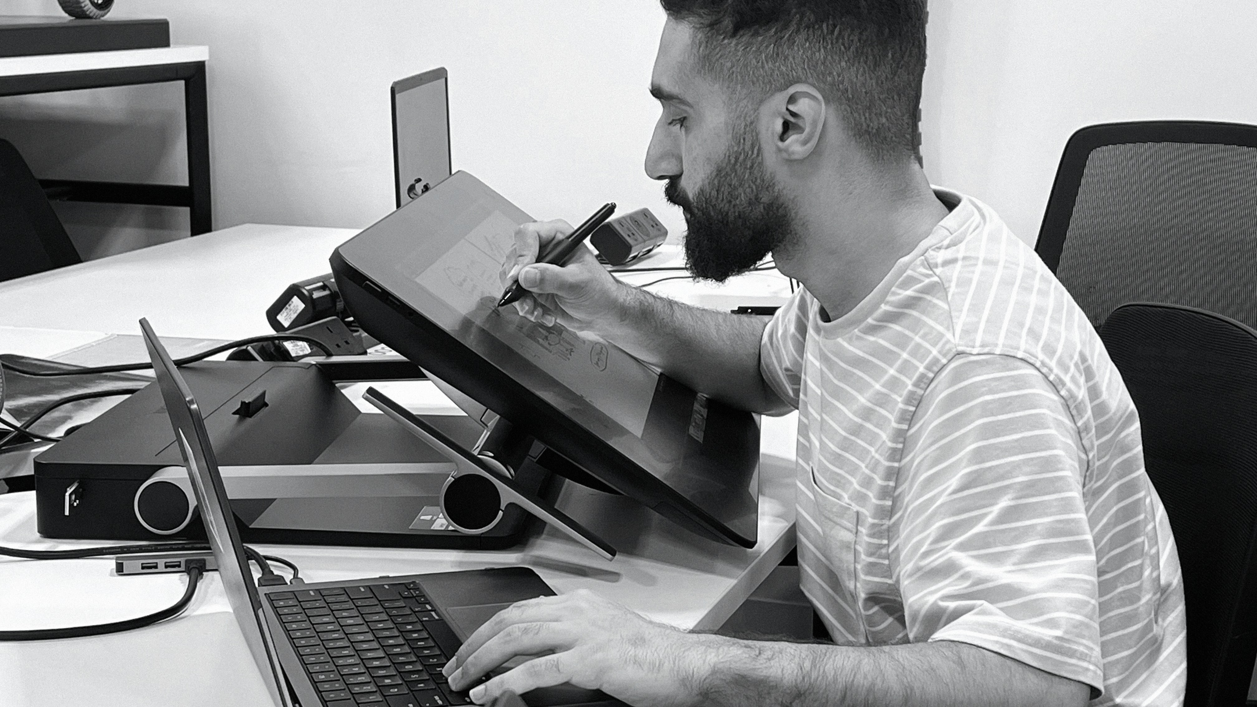 A close-up of a hand wearing multiple decorative rings against a blue background.