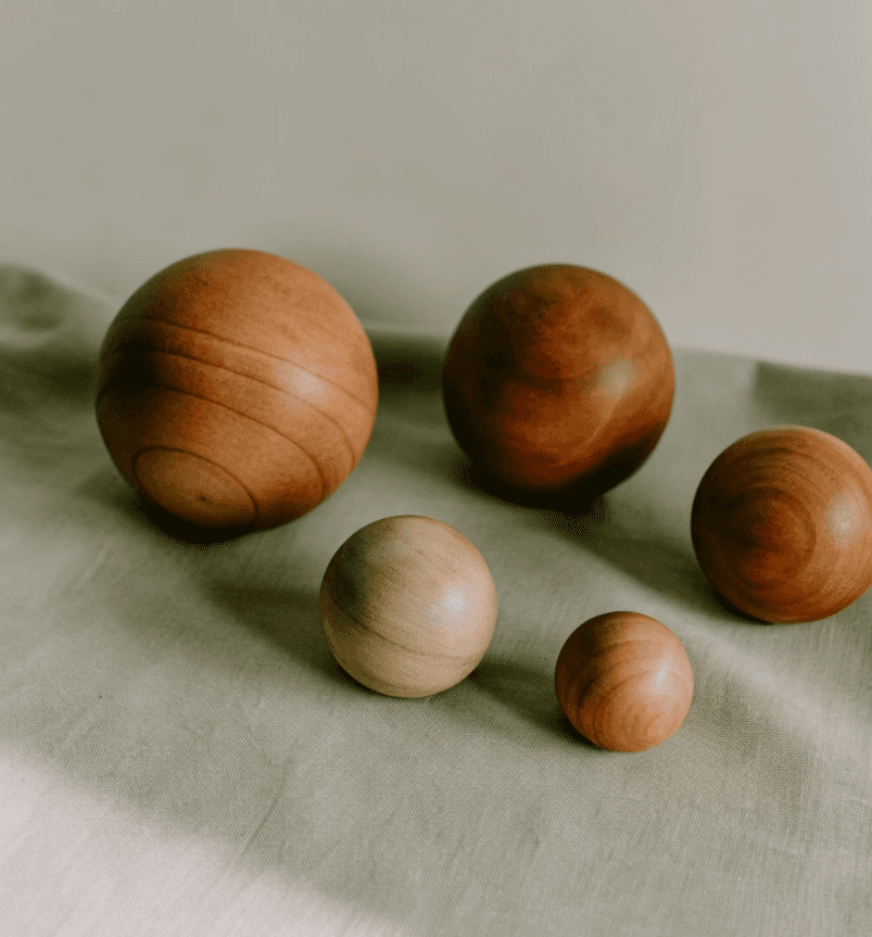 Toned woman does yoga side bend pose by foggy lakeside.