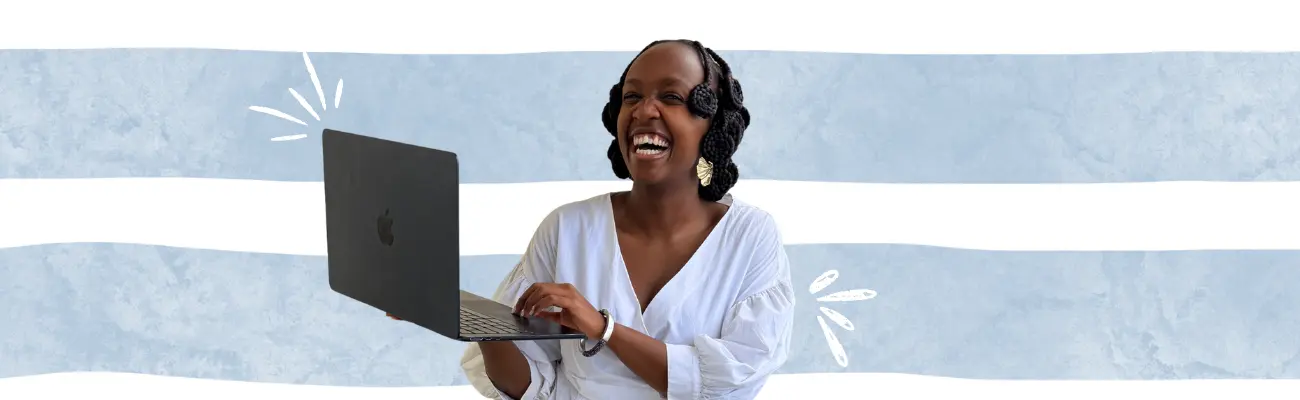 Waggs Design Studio Founder smiling and holding a laptop