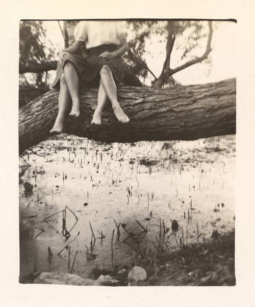 A ballerina with long hair throws her arms up