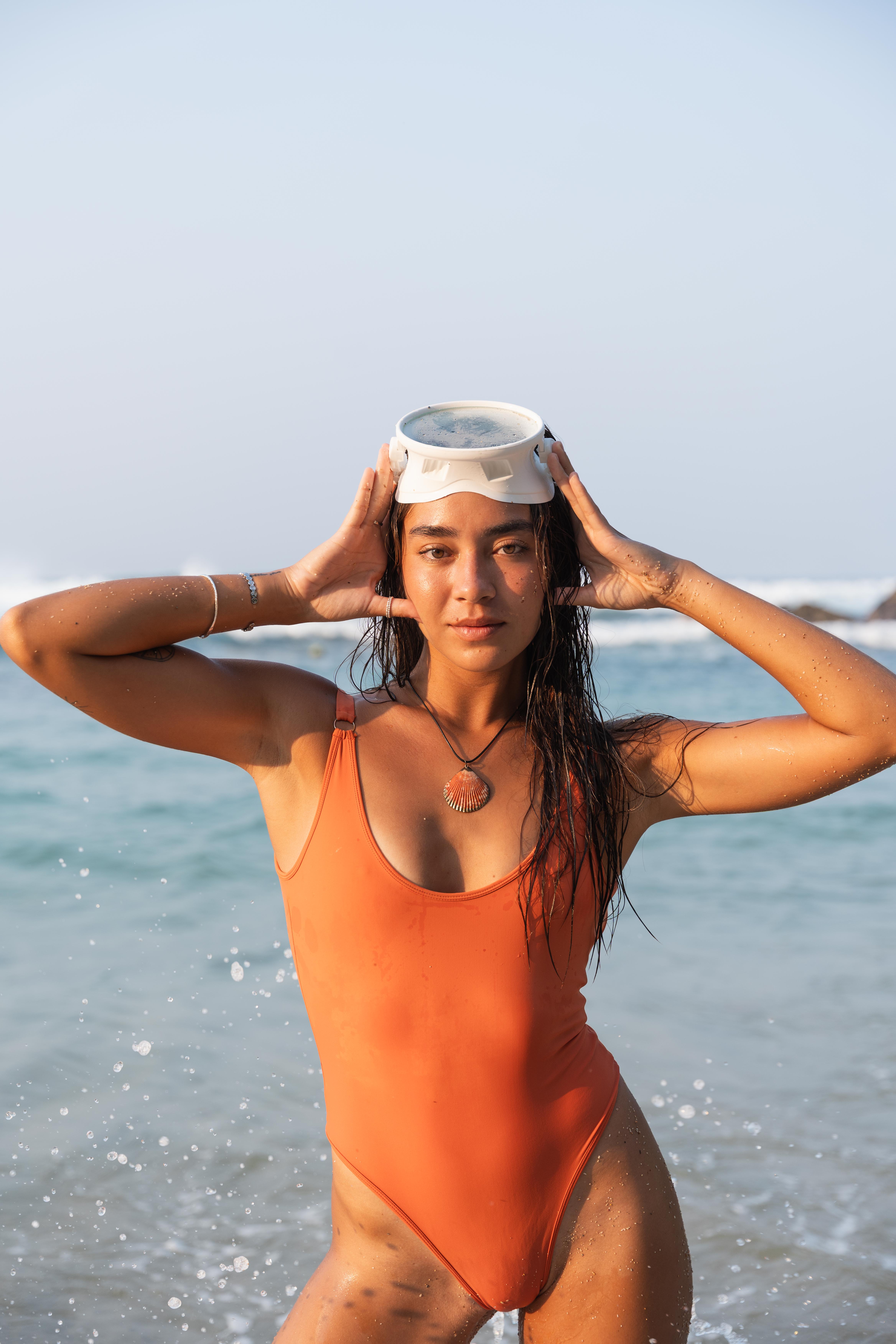 Girl posing for camera with white goggles on her head