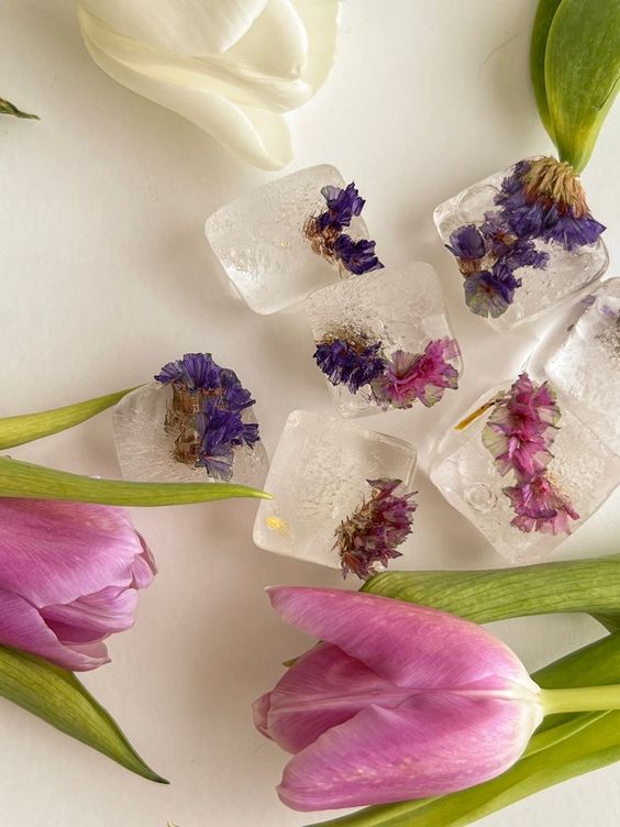 pink and lavender flowers frozen inside an ice cube