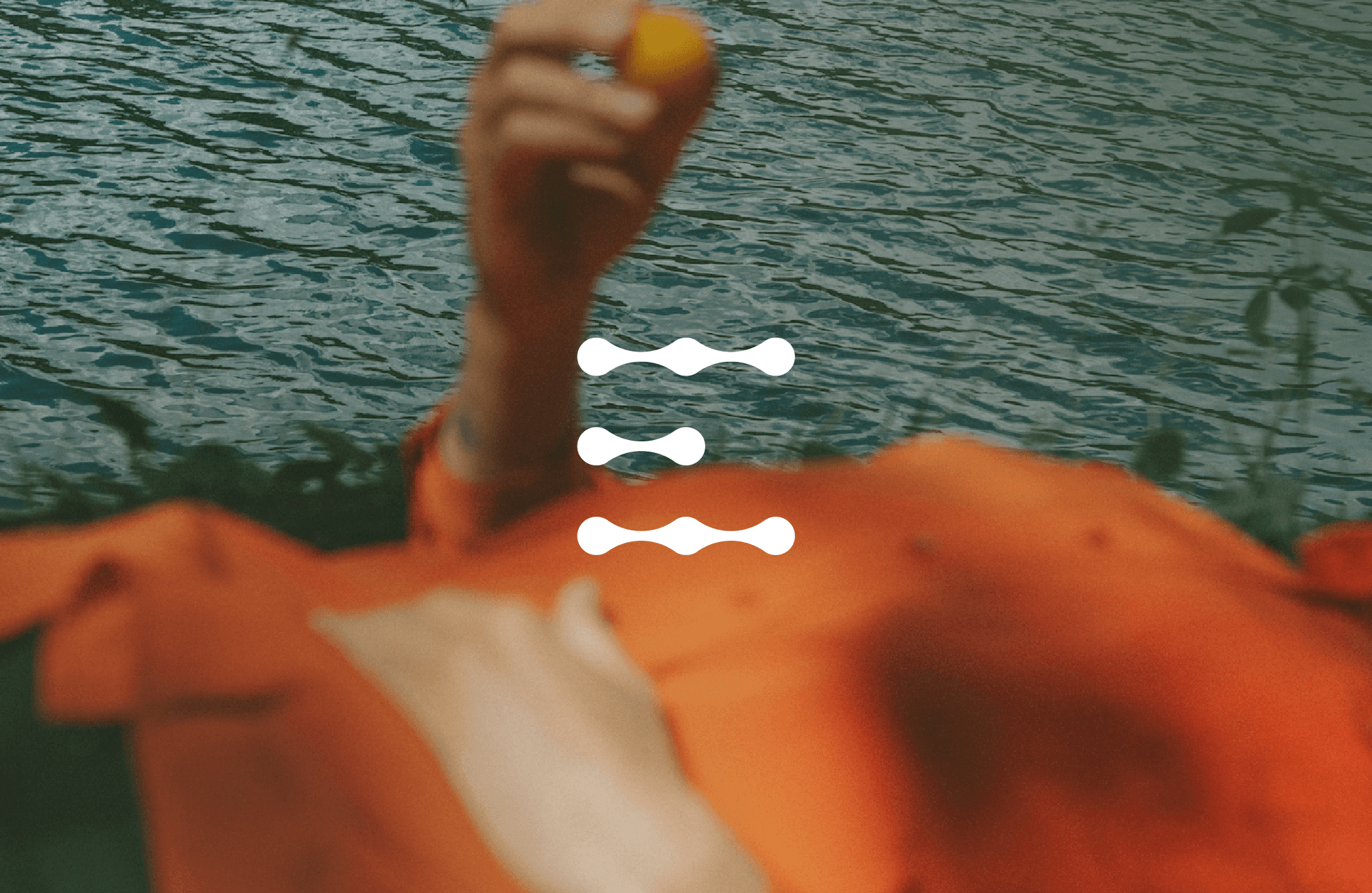 Entera logo on top of a photo of the torso of a woman laying on her back while holding a fruit and a hand on her stomach