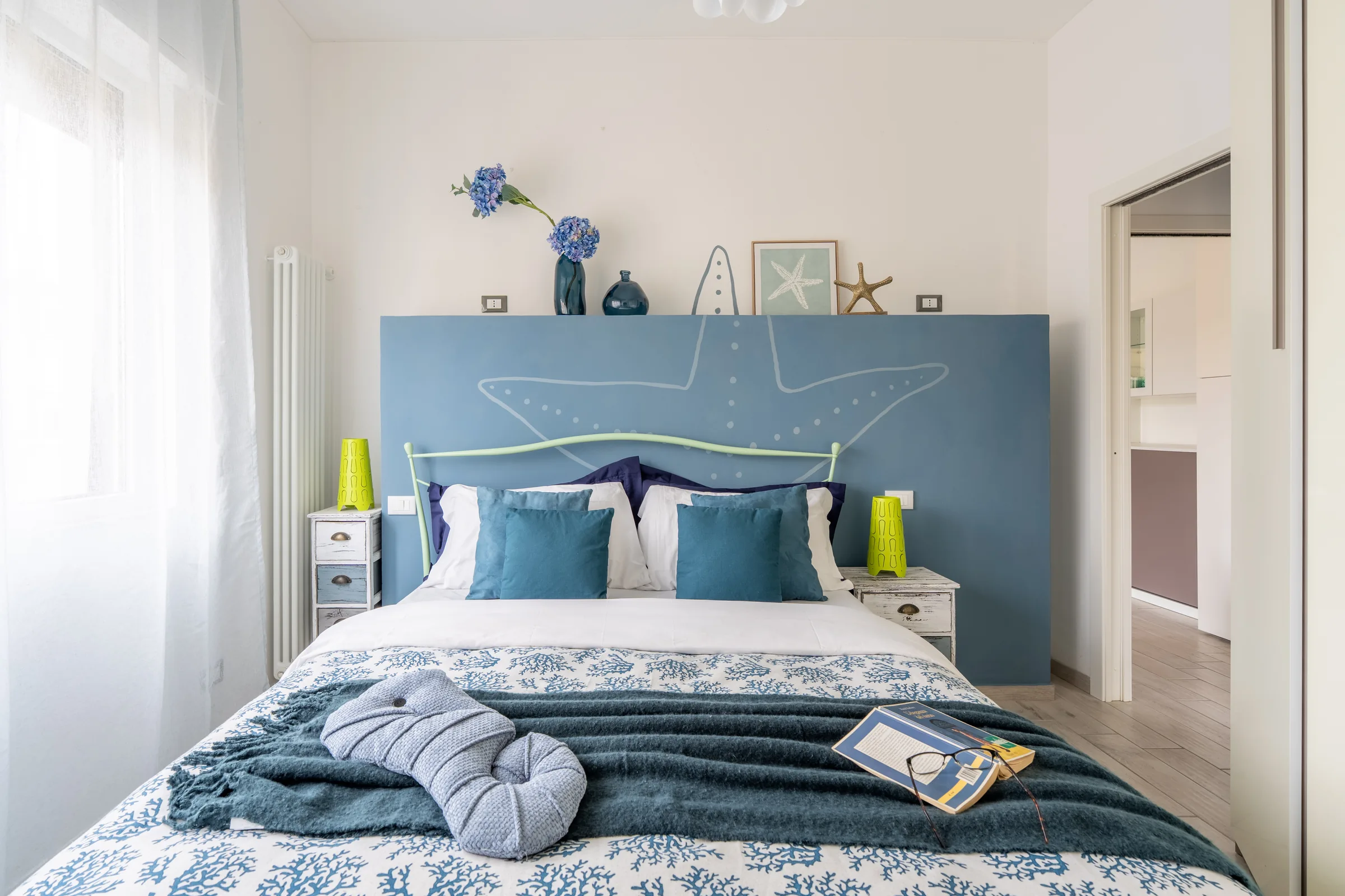Bedroom with blue details — Province of Imperia, Italy. Photography by Yunes Calore.