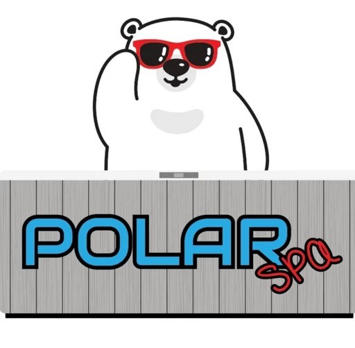 Smiling woman with dark hair wearing a black blazer and white blouse. She stands outdoors with geometric sculpture and trees in the background