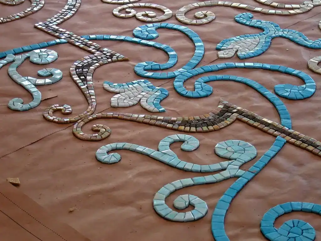 Tiling in progress across the pool floor, second stage — Mosaiclegs Art Studio