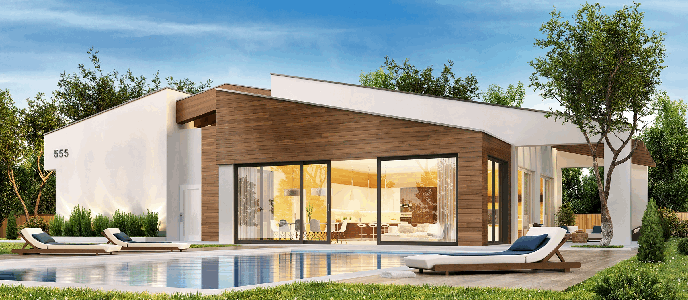 Modern indoor space with large glass doors, lush greenery, and a cozy seating area visible beyond.