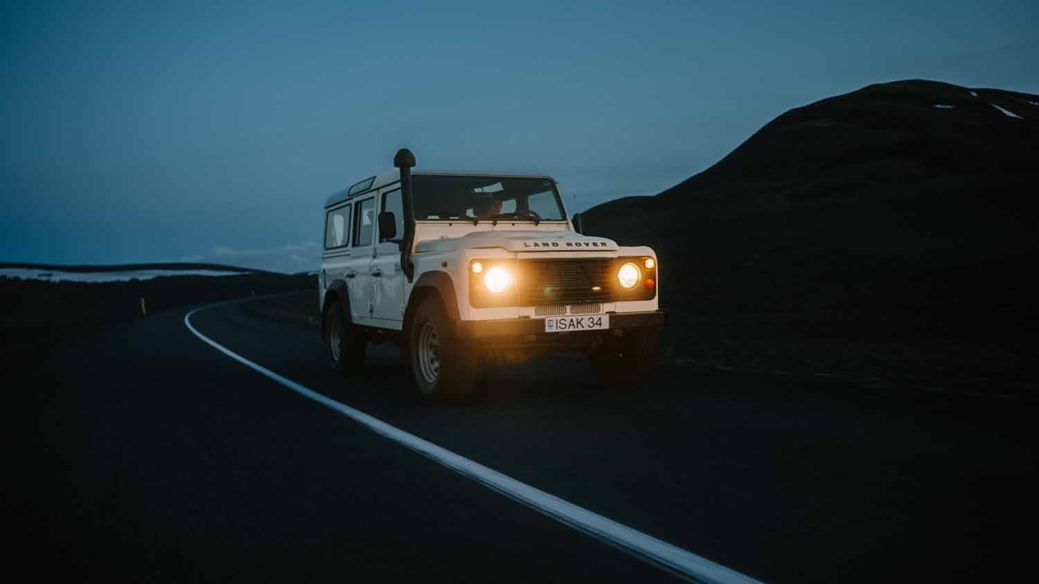 Off-road vehicle on a dusk road; captured for a landcover ad.