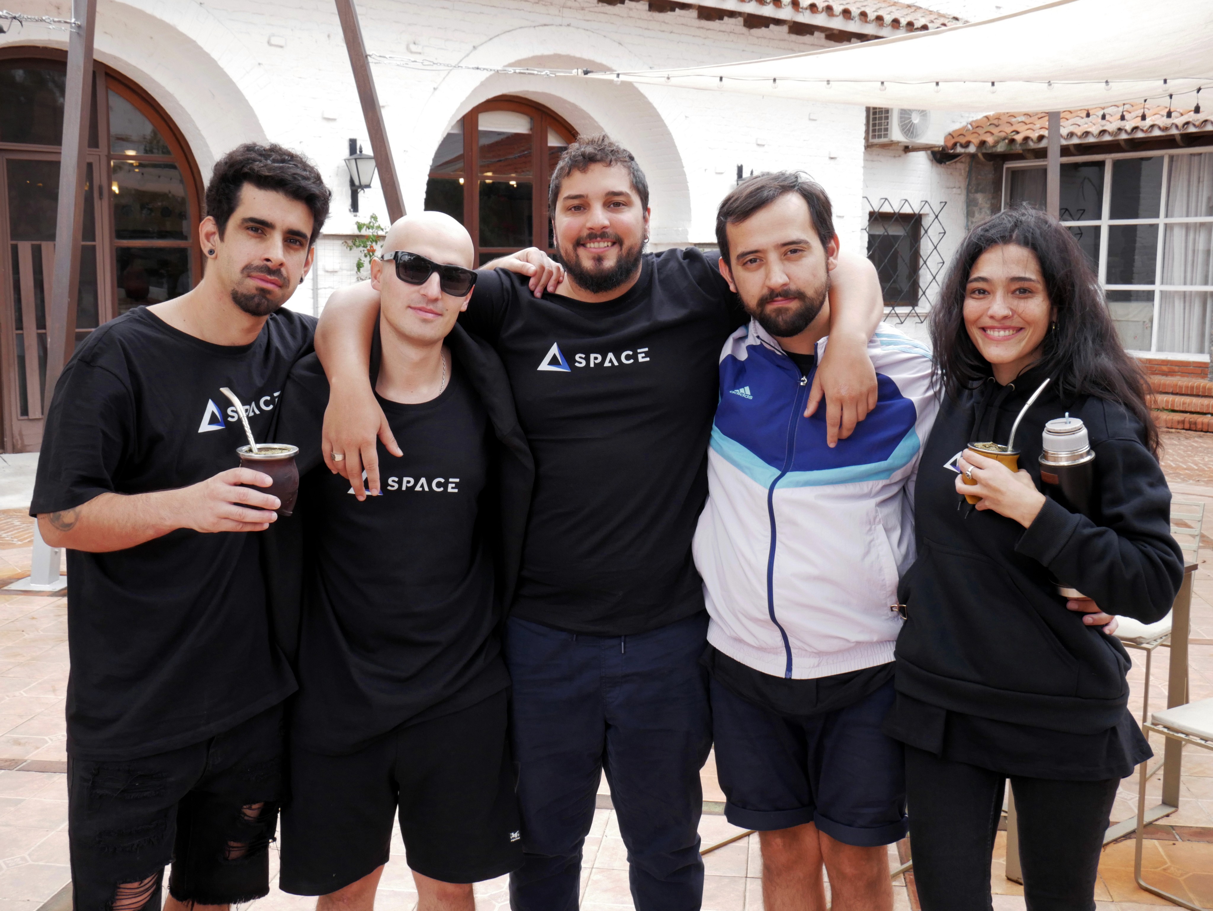 SpaceDev team members posing together and enjoying mate at the All Hands event.