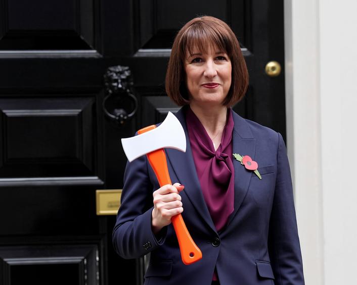 An AI edited image showing Rachel Reeves, UK Chancellor of the Exchequer, holding a toy axe outside 10 Dowing Street