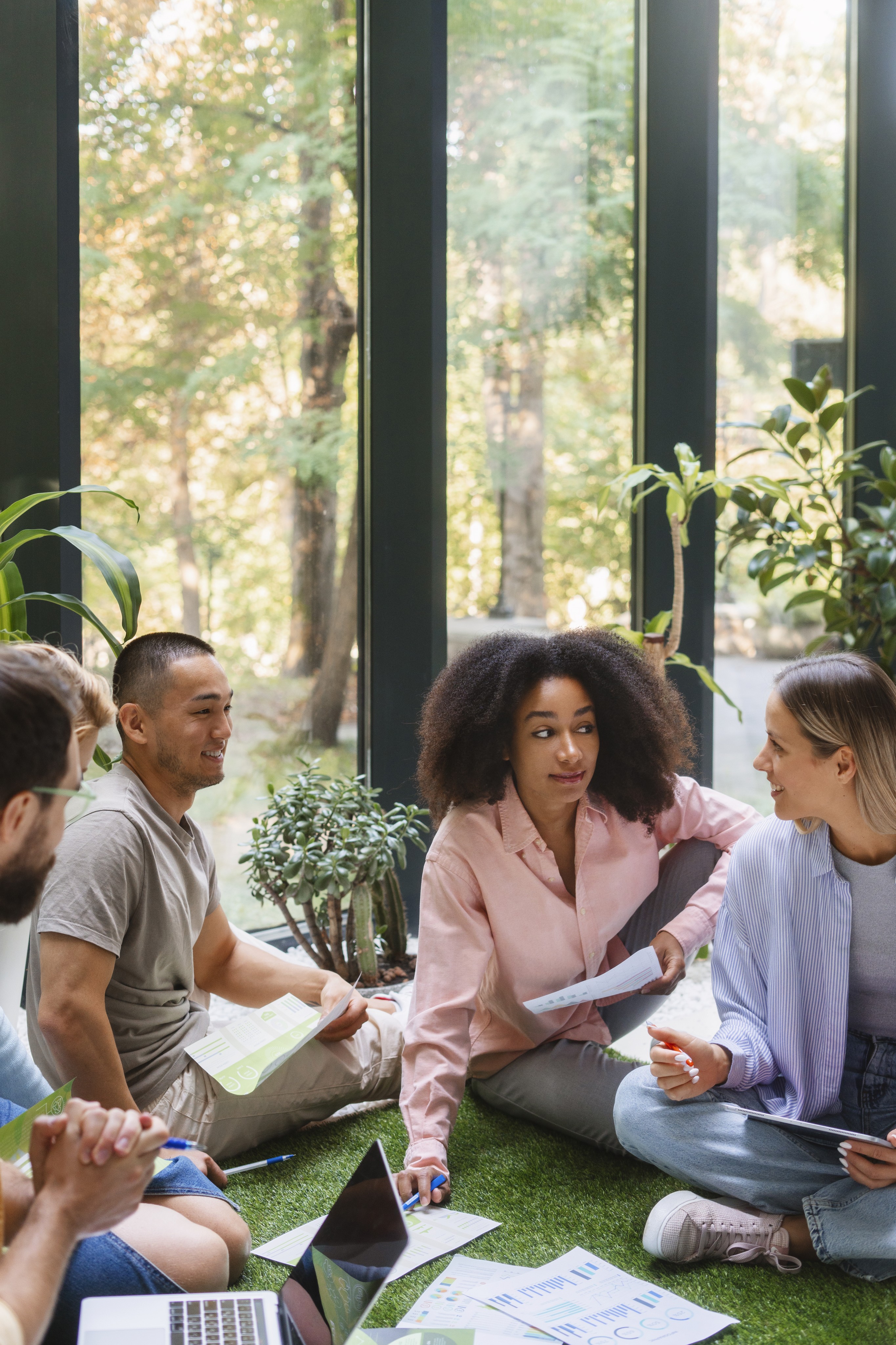 Close-up of a dark green leaf showing its textured surface and central vein against a muted background.