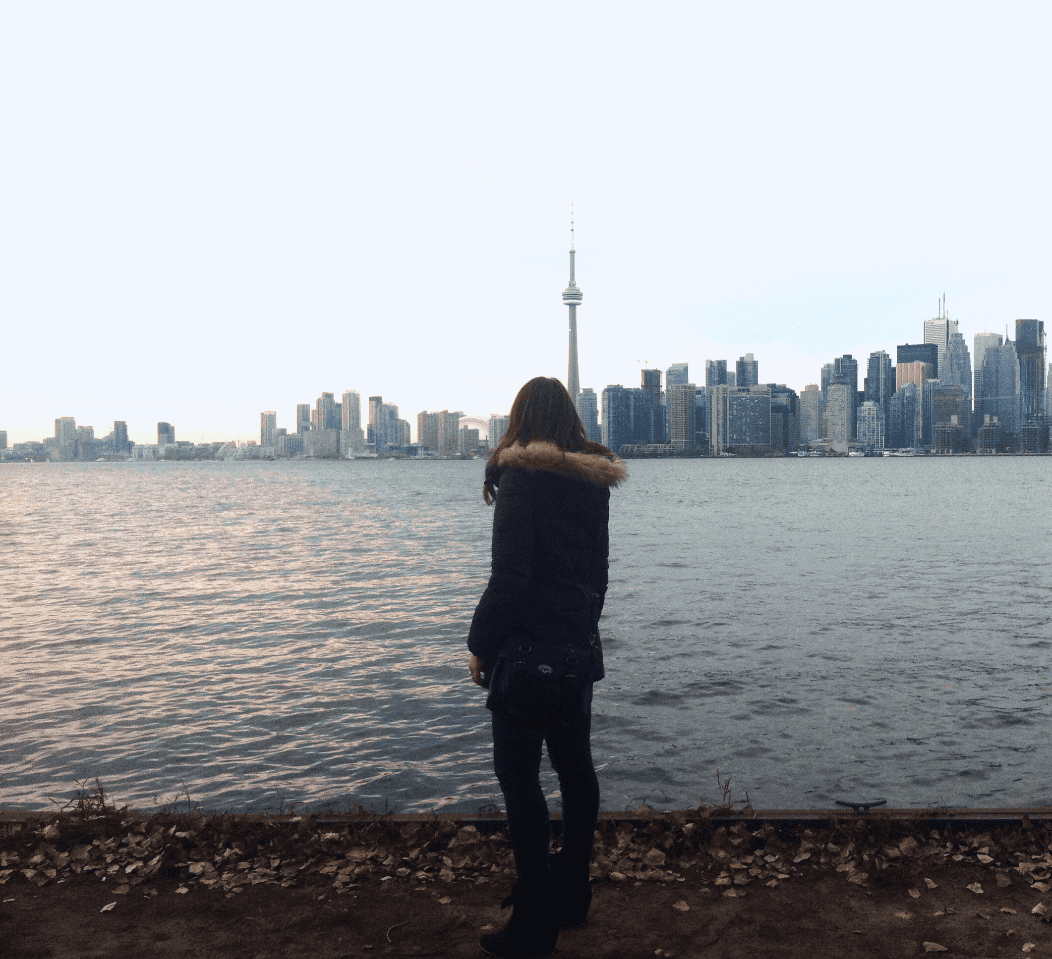 a-woman-looking-at-CNTower-Toronto-bay-skyline