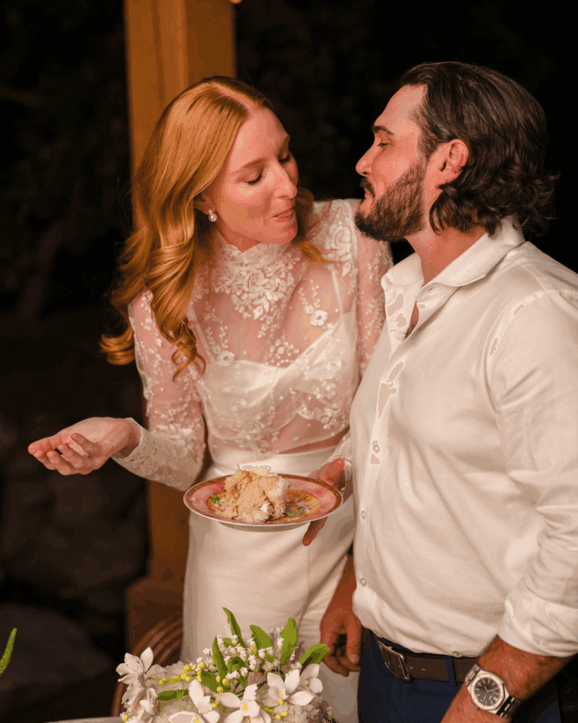 Newlyweds feeding each other cake