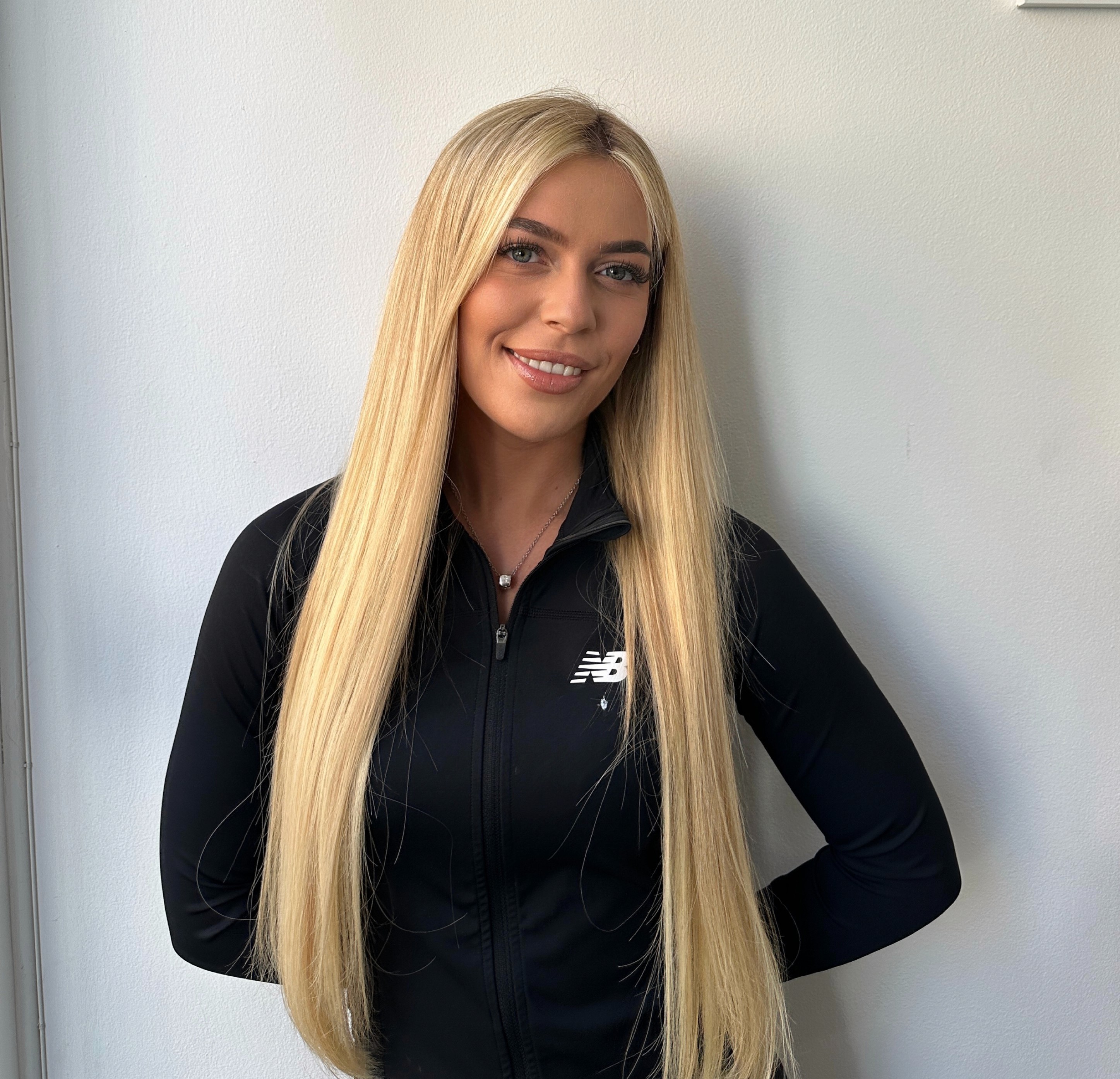 Blonde nail technician smiling