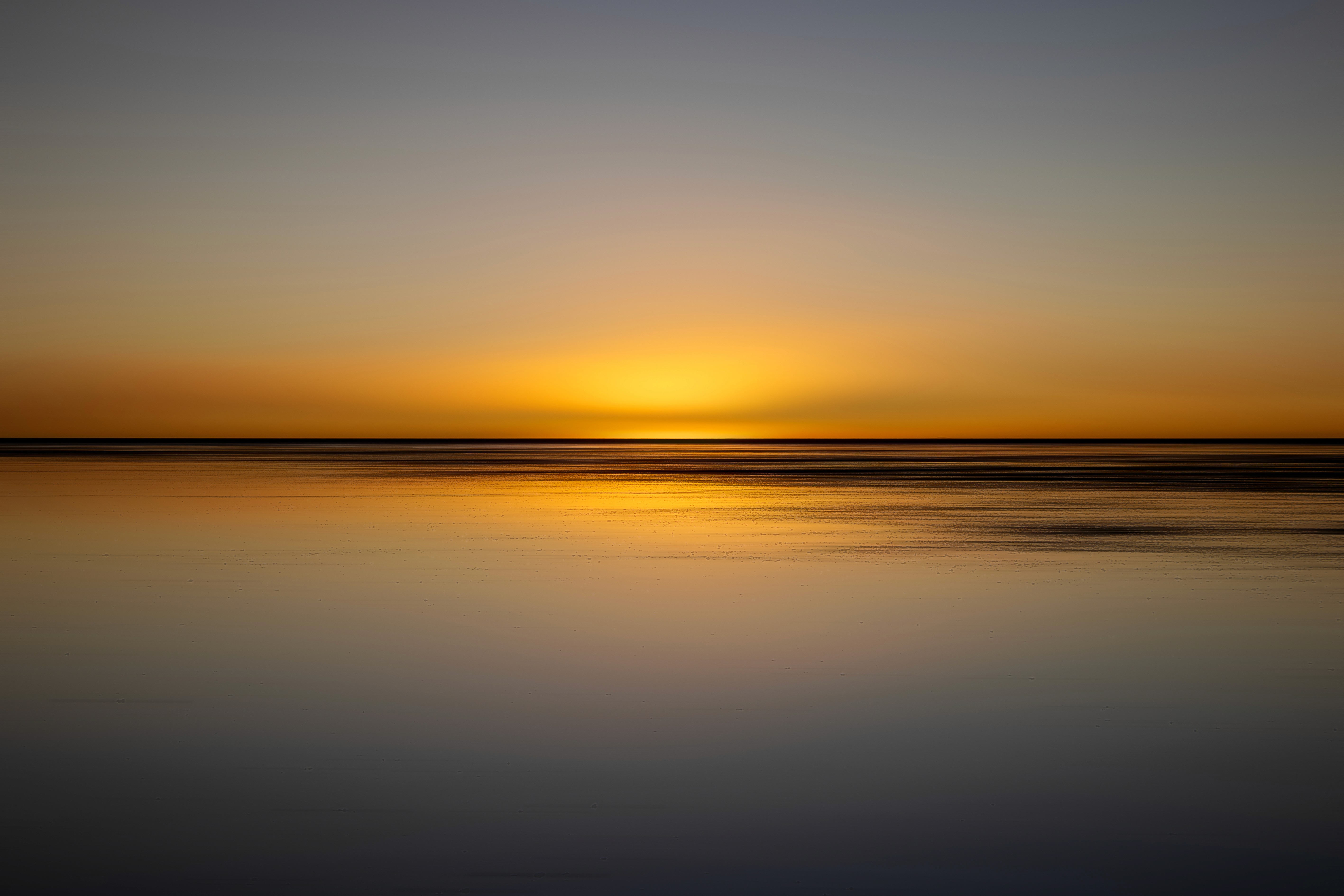 Serene minimalist seascape at sunset with warm orange tones and soft water reflections, by Benjamin Hernandez.