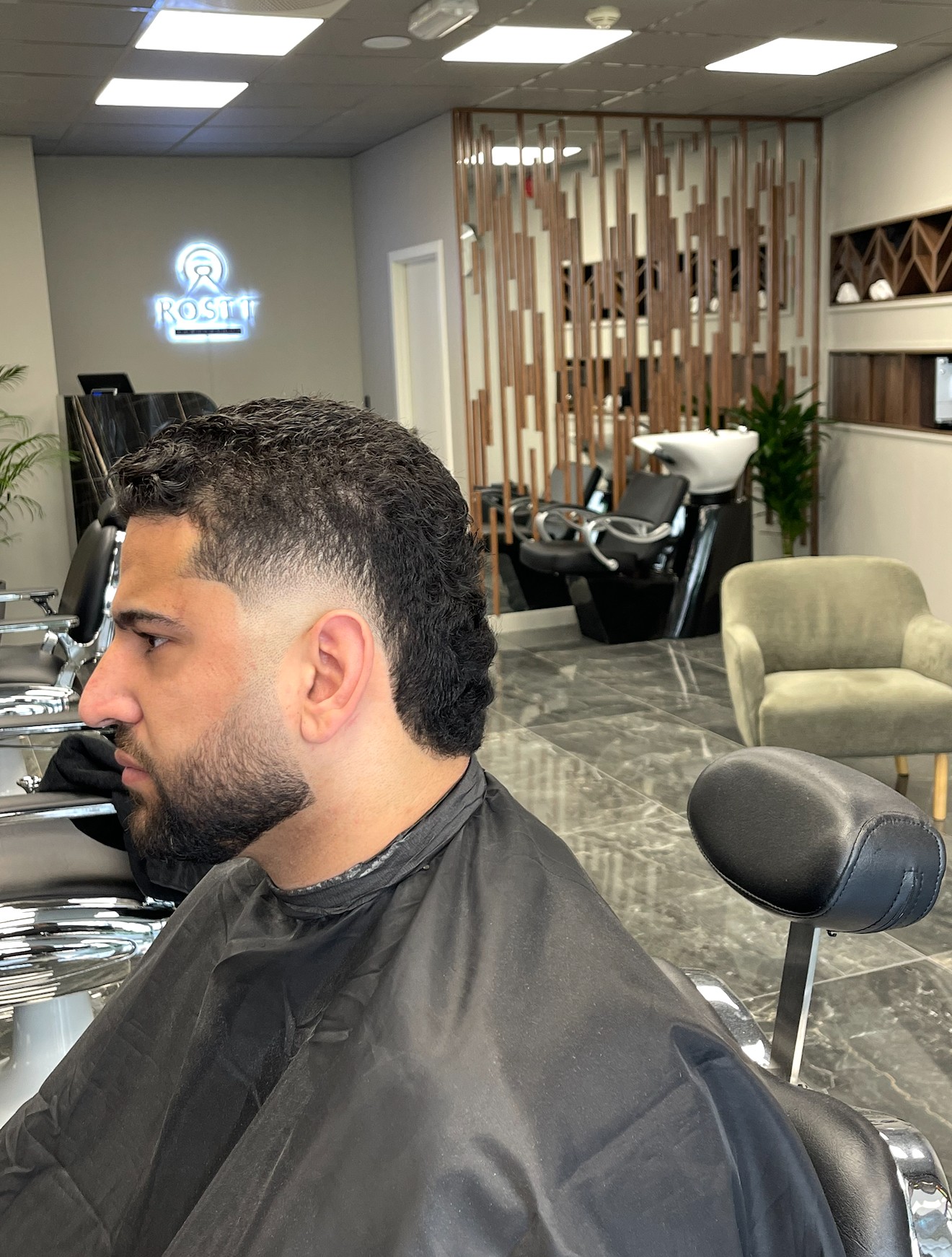 Salon styling station with gold-framed mirrors