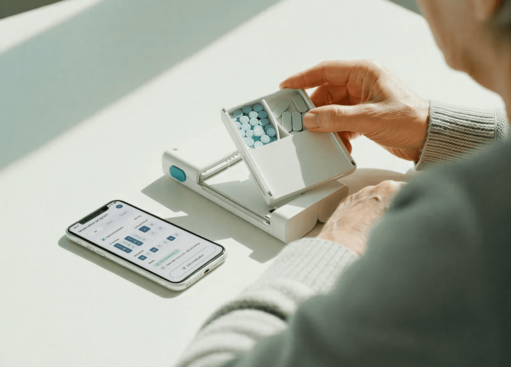 Patient filling the Medicase device with medications in bulk following app instructions